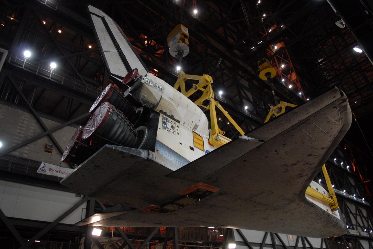 CAPE CANAVERAL, Fla. -- In the Vehicle Assembly Building transfer aisle at NASA's Kennedy Space Center in Florida, space shuttle Discovery is lifted from its transporter by an overhead crane. The shuttle will be raised to a vertical position and lifted into high bay 3 where it will be mated with its external fuel tank and solid rocket boosters on the mobile launcher platform. After additional preparations are made, the shuttle will be rolled out to Launch Pad 39A for a targeted launch on Feb. 12. Discovery will carry the final starboard truss (S6) in the assembly of the International Space Station. Photo credit: NASA/Troy Cryder