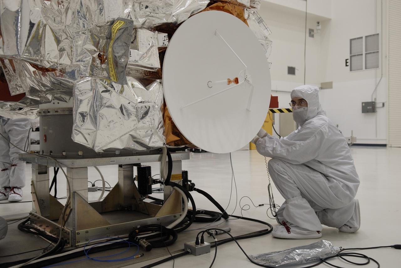 CAPE CANAVERAL, Fla. -- At the Astrotech payload processing facility in Titusville, Fla., a worker inspects the high-gain antenna on NASA's Kepler spacecraft in preparation for testing. A NASA Discovery mission, Kepler is specifically designed to survey our region of the Milky Way galaxy to discover hundreds of Earth-size and smaller planets in or near the habitable zone and determine how many of the billions of stars in our galaxy have such planets. Results from this mission will allow us to place our solar system within the continuum of planetary systems in the Galaxy. After processing at Astrotech, Kepler will be carried to its launch pad at Cape Canaveral. .NASA's planet-hunting Kepler mission is scheduled to launch no earlier than March 5 atop a Delta II rocket. Photo credit: NASA/Kim Shiflett
