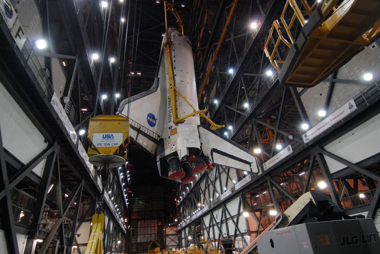 CAPE CANAVERAL, Fla. -- In the Vehicle Assembly Building at NASA's Kennedy Space Center in Florida, space shuttle Discovery is lifted into the upper levels for transfer to high bay 3. The shuttle will then be lowered onto the mobile launcher platform for mating with its external fuel tank and solid rocket boosters. After additional preparations are made, the shuttle will be rolled out to Launch Pad 39A for a targeted launch on Feb. 12. Discovery will carry the final starboard truss (S6) in the assembly of the International Space Station. Photo credit: NASA/Jack Pfaller