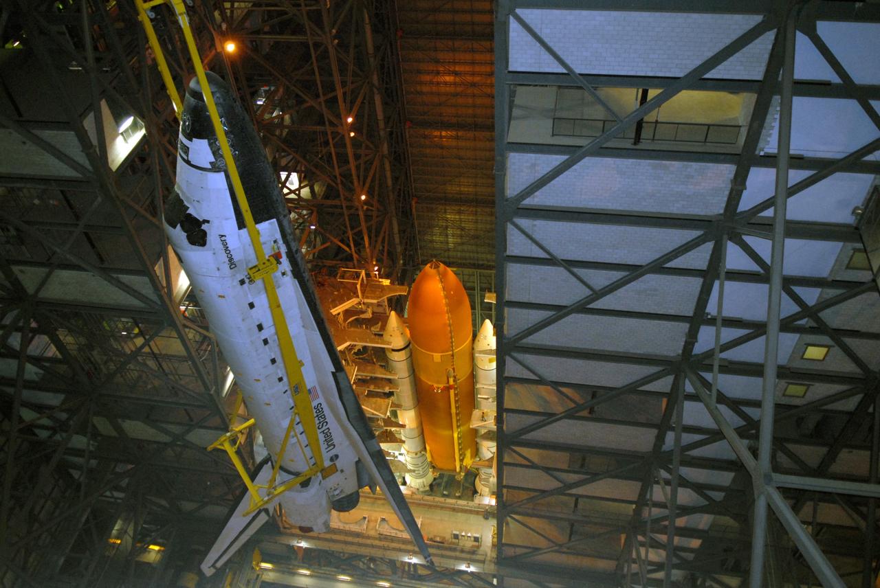 CAPE CANAVERAL, Fla. -- In the upper levels of the Vehicle Assembly Building at NASA's Kennedy Space Center in Florida, space shuttle Discovery is moved toward high bay 3 where the external fuel tank and solid rocket boosters are already stacked on the mobile launcher platform. Discovery will be lowered onto the platform and mated with the stack. After additional preparations are made, the shuttle will be rolled out to Launch Pad 39A for a targeted launch on Feb. 12. Discovery will carry the final starboard truss (S6) in the assembly of the International Space Station. Photo credit: NASA/Jack Pfaller