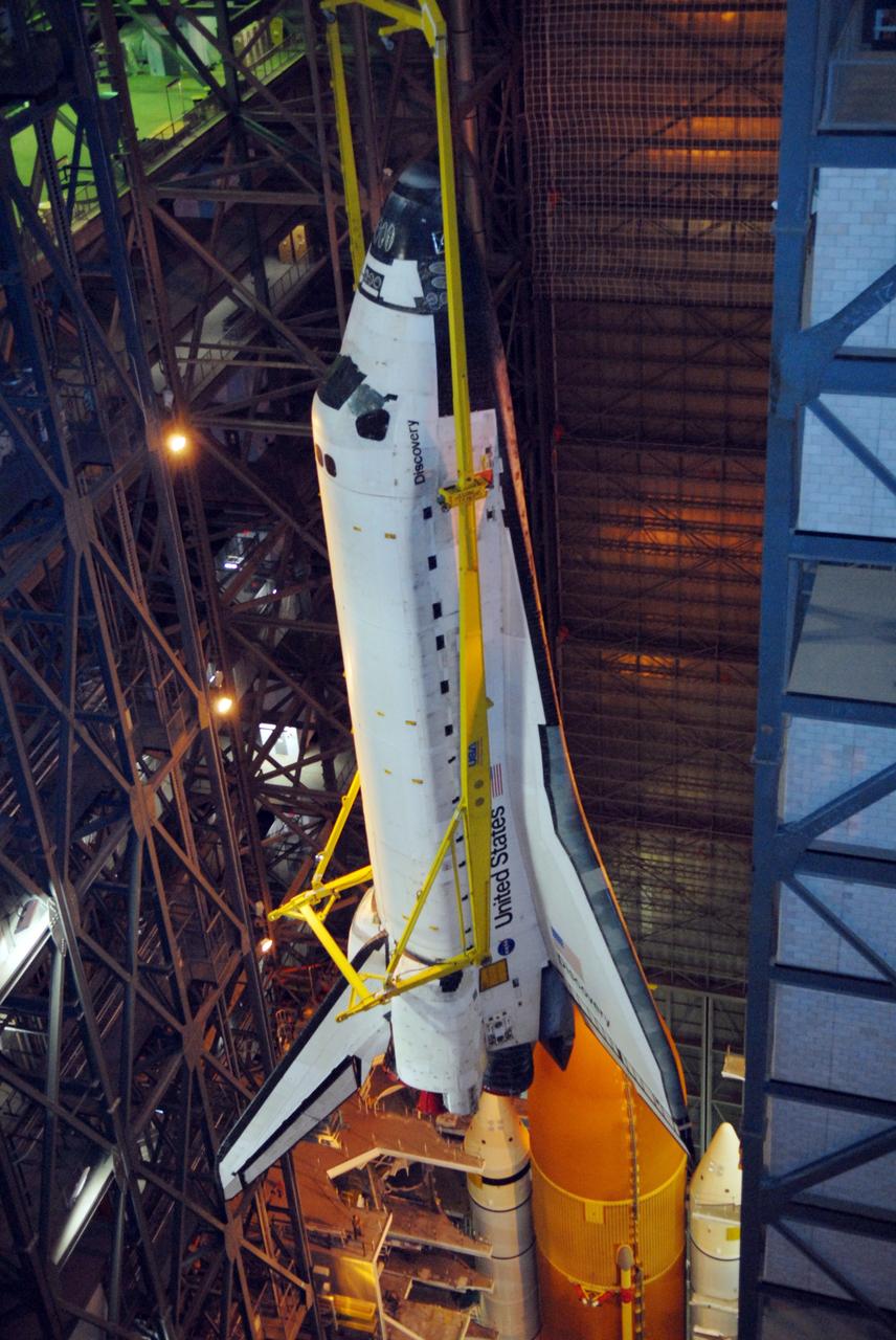 CAPE CANAVERAL, Fla. -- From the upper levels of the Vehicle Assembly Building at NASA's Kennedy Space Center in Florida, space shuttle Discovery is lowered into high bay 3 where the external fuel tank and solid rocket boosters are already stacked on the mobile launcher platform. Discovery will be mated with the stack. After additional preparations are made, the shuttle will be rolled out to Launch Pad 39A for a targeted launch on Feb. 12. Discovery will carry the final starboard truss (S6) in the assembly of the International Space Station. Photo credit: NASA/Jack Pfaller
