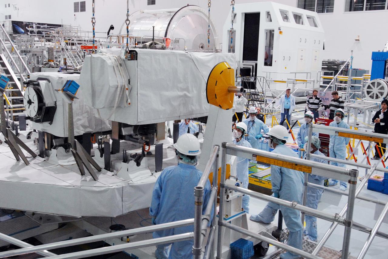 CAPE CANAVERAL, Fla. -- In the Space Station Processing Facility at NASA's Kennedy Space Center in Florida, a crane lowers the MAXI (Monitor of All-sky X-ray Image) onto the Payload Attachment Mechanism on the Japanese Experiment Module's Experiment Logistics Module-Exposed Section, or ELM-ES. It is being installed next to the SEDA-AP (Space Environment Data Acquisition Equipment-Attached Payload). The MAXI and SEDA-AP are part of space shuttle Endeavour's payload on the STS-127 mission. Using X-ray slit cameras with high sensitivity, the MAXI will continuously monitor astronomical X-ray objects over a broad energy band (0.5 to 30 keV). Endeavour is targeted to launch May 15. Photo credit: NASA/Jim Grossmann