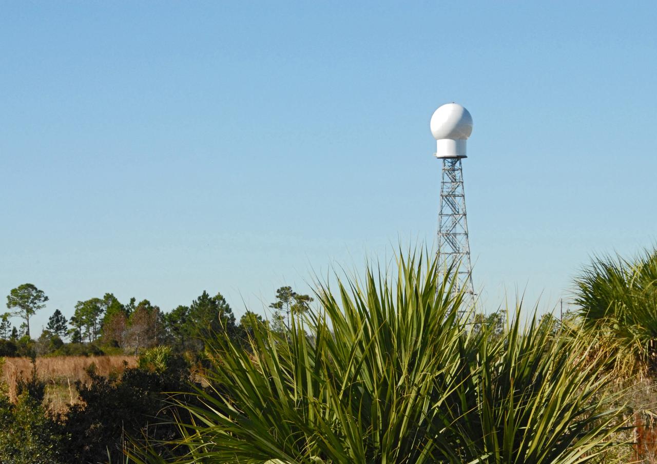 CAPE CANAVERAL, Fla. -- A replacement weather Doppler radar has been installed on top of this tower in a remote field located west of NASA's Kennedy Space Center in Florida. The radome houses the rotating antenna and pedestal and protects them from the elements. The tower is 100 feet high; the radome is 22 feet in diameter, the antenna 14 feet in diameter. It rotates at 6 rpm. The structure can withstand 130 mph winds. It is undergoing initial testing and expected to become operational in the summer. The weather radar is essential in issuing lightning and other severe weather warnings and vital in evaluating lightning launch commit criteria for space shuttle and rocket launches. Photo credit: NASA/Troy Cryder