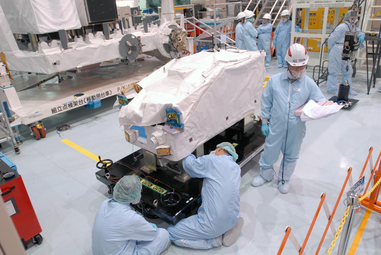 CAPE CANAVERAL, Fla. -- In the Space Station Processing Facility at NASA's Kennedy Space Center in Florida, workers prepare the ICS Exposed Facility, ICS-EF, to be lifted and installed on the Japanese Experiment Module's Experiment Logistics Module-Exposed Section, or ELM-ES. The ICS-EF is composed of several components, including an antenna, pointing mechanism, frequency converters, high-power amplifier and various sensors including the Earth sensor, Sun sensor and inertial reference unit. The ICS-EF is part of space shuttle Endeavour's payload on the STS-127 mission, targeted for launch on May 15. Photo credit: NASA/Jim Grossmann