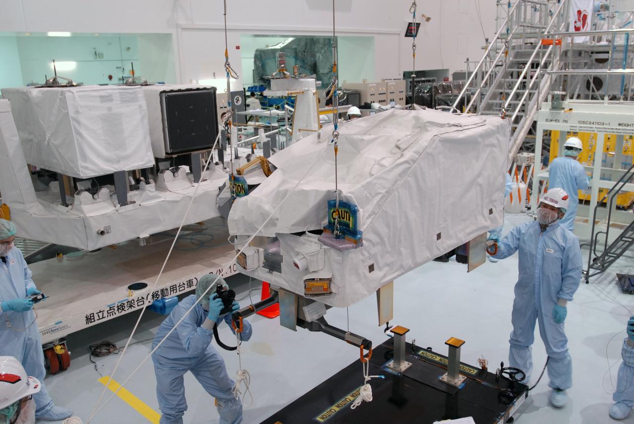 CAPE CANAVERAL, Fla. --   In the Space Station Processing Facility at NASA's Kennedy Space Center in Florida, workers examine the ICS Exposed Facility, or ICS-EF, after it is lifted from its stand. It will be installed on the Japanese Experiment Module's Experiment Logistics Module-Exposed Section, or ELM-ES. The ICS-EF is composed of several components, including an antenna, pointing mechanism, frequency converters, high-power amplifier and various sensors including the Earth sensor, Sun sensor and inertial reference unit. The ICS-EF is part of space shuttle Endeavour's payload on the STS-127 mission, targeted for launch on May 15. Photo credit: NASA/Jim Grossmann