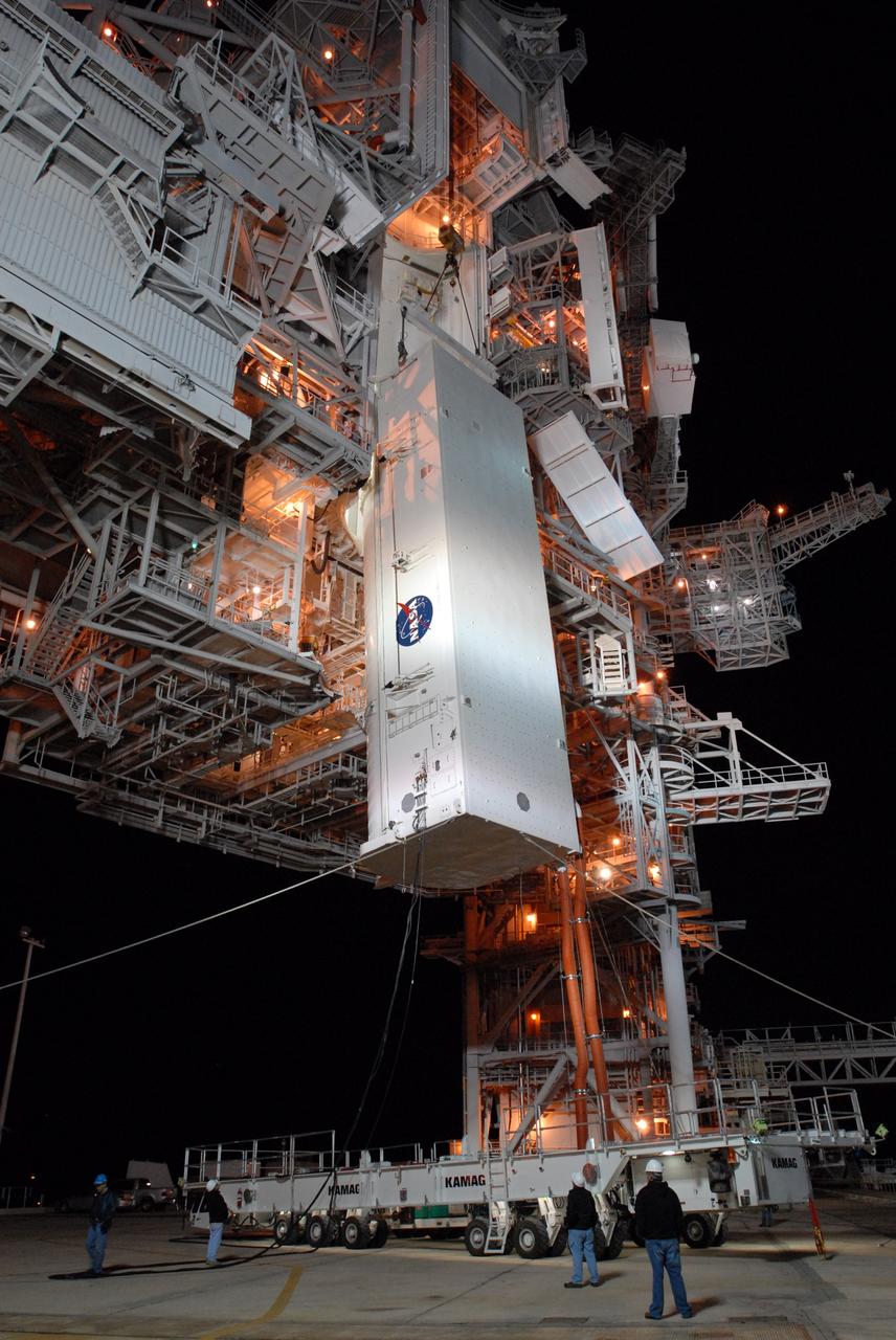 CAPE CANAVERAL, Fla. --  With red umbilical lines attached, the payload containing space shuttle Discovery's S6 truss and solar arrays is lifted up to the Payload Changeout Room, or PCR, on Launch Pad 39A at NASA's Kennedy Space Center in Florida. The payload will be transferred inside the PCR where it will wait until Discovery rolls out to the pad. Then the payload will be installed in the shuttle's payload bay. Launch of Discovery on the STS-119 mission is scheduled for Feb. 12. During Discovery's 14-day mission, the crew will install the S6 truss segment and its solar arrays to the starboard side of the station, completing the station's backbone, or truss.  Photo credit: NASA/Jim Grossmann