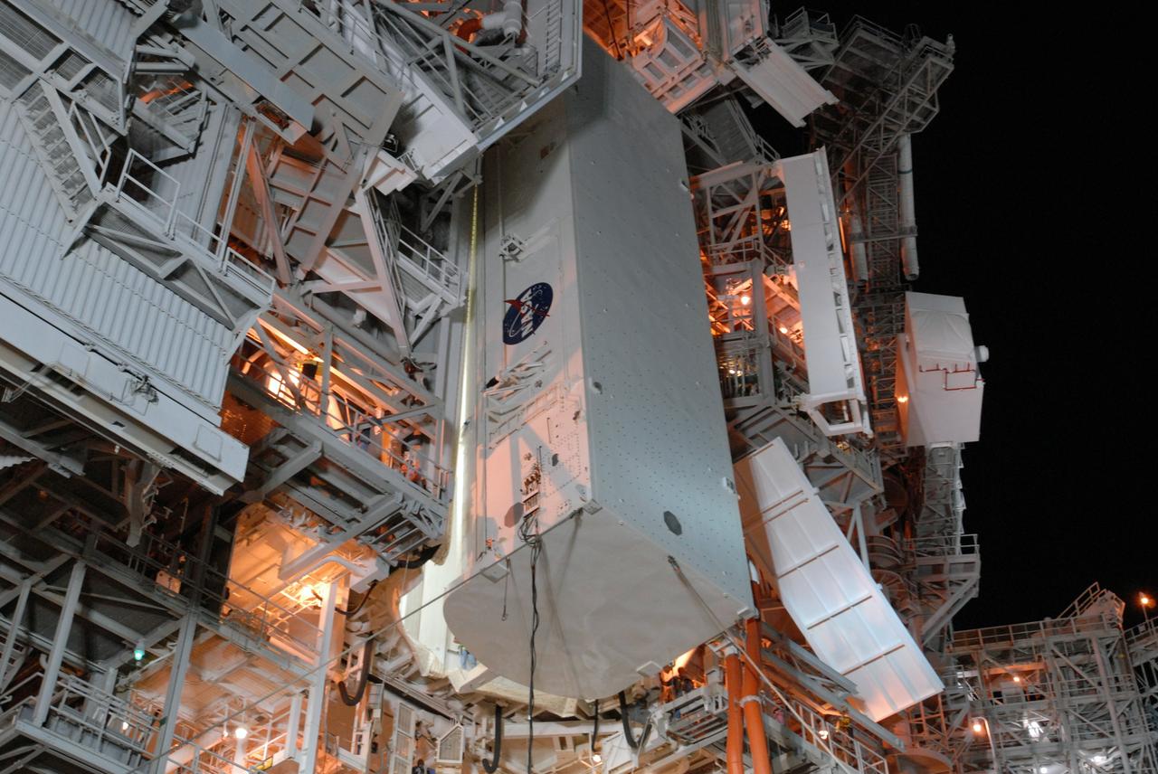 CAPE CANAVERAL, Fla. --  With red umbilical lines attached, the payload containing space shuttle Discovery's S6 truss and solar arrays is lifted up to the Payload Changeout Room, or PCR, on Launch Pad 39A at NASA's Kennedy Space Center in Florida. The payload will be transferred inside the PCR where it will wait until Discovery rolls out to the pad. Then the payload will be installed in the shuttle's payload bay. Launch of Discovery on the STS-119 mission is scheduled for Feb. 12. During Discovery's 14-day mission, the crew will install the S6 truss segment and its solar arrays to the starboard side of the station, completing the station's backbone, or truss Photo credit: NASA/Jim Grossmann