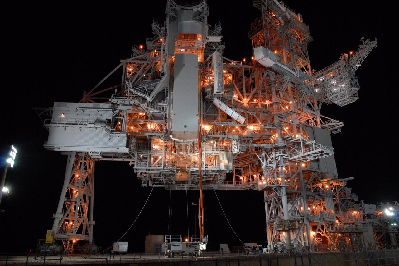 CAPE CANAVERAL, Fla. --  With red umbilical lines attached, the payload containing space shuttle Discovery's S6 truss and solar arrays is lifted up to the Payload Changeout Room, or PCR, on Launch Pad 39A at NASA's Kennedy Space Center in Florida. The payload will be transferred inside the PCR where it will wait until Discovery rolls out to the pad. Then the payload will be installed in the shuttle's payload bay. Launch of Discovery on the STS-119 mission is scheduled for Feb. 12. During Discovery's 14-day mission, the crew will install the S6 truss segment and its solar arrays to the starboard side of the station, completing the station's backbone, or truss Photo credit: NASA/Jim Grossmann