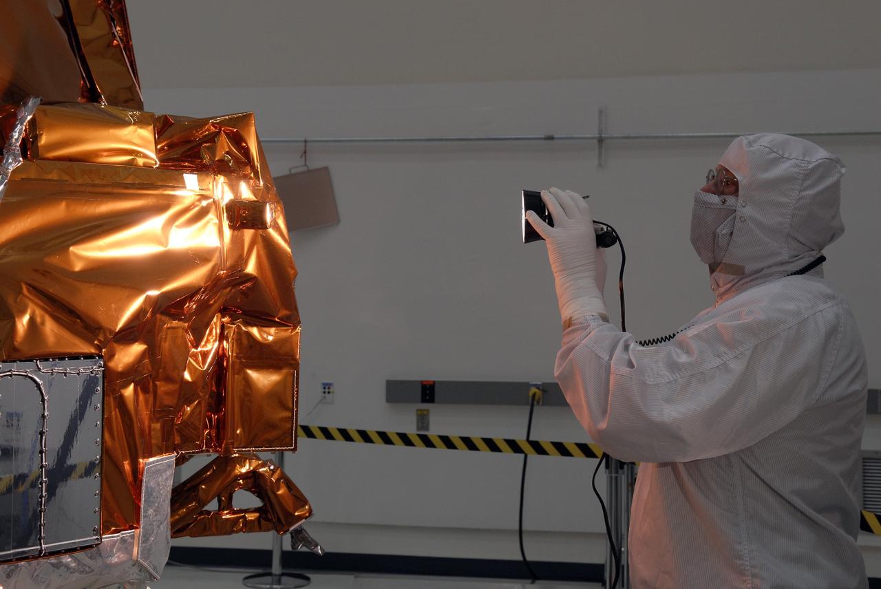 CAPE CANAVERAL, Fla. -- At the Astrotech payload processing facility in Titusville, Fla., a Ball Aerospace and Technologies Corp. worker conducts a light sensor test on NASA's Kepler spacecraft. A NASA Discovery mission, Kepler is specifically designed to survey our region of the Milky Way galaxy to discover hundreds of Earth-size and smaller planets in or near the habitable zone and determine how many of the billions of stars in our galaxy have such planets. Results from this mission will allow us to place our solar system within the continuum of planetary systems in the Galaxy. After processing at Astrotech, Kepler will be carried to its launch pad at Cape Canaveral Air Force Station. .NASA's planet-hunting Kepler mission is scheduled to launch no earlier than March 5 atop a United Launch Alliance Delta II rocket. Photo credit: NASA/Kim Shiflett
