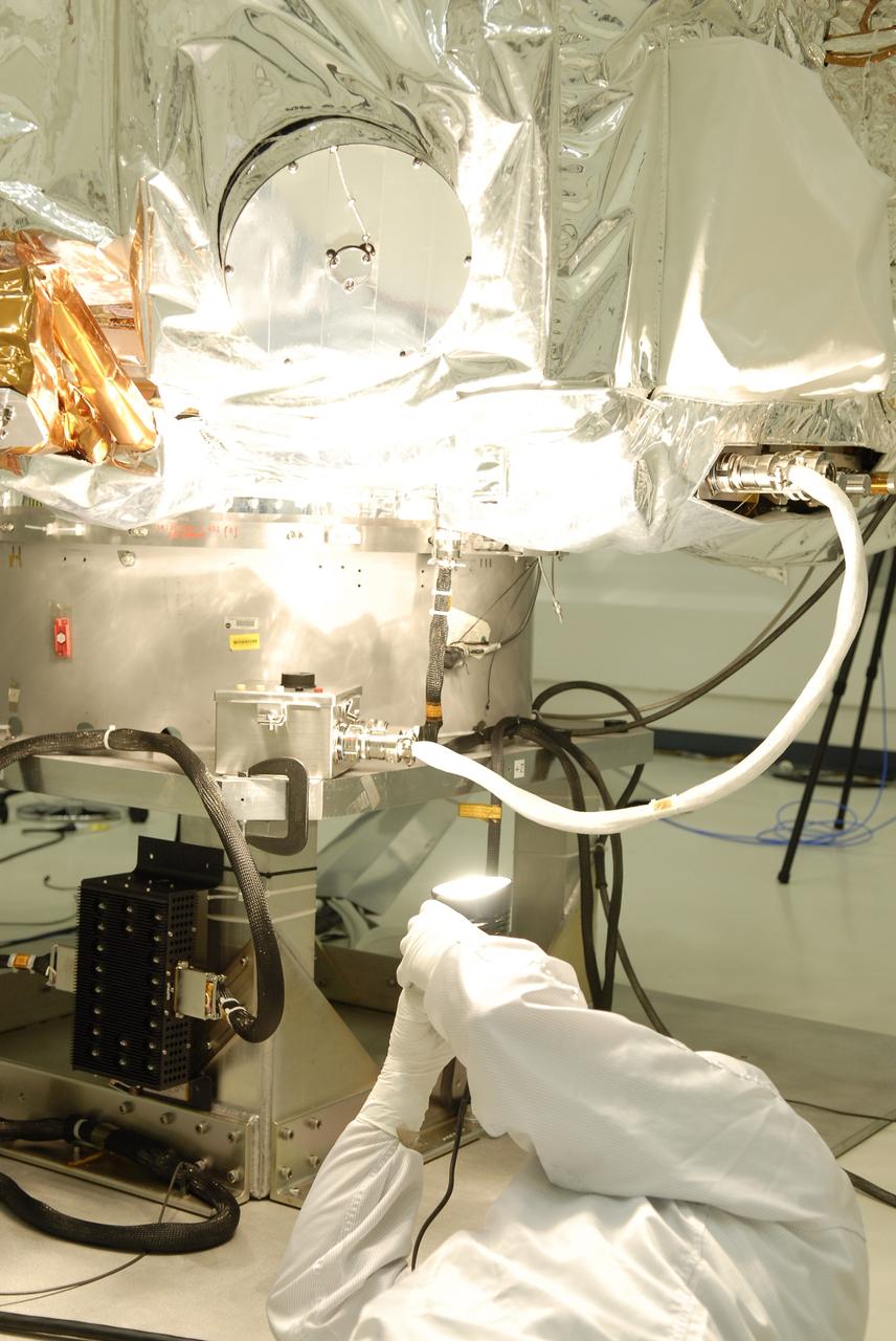 CAPE CANAVERAL, Fla. -- At the Astrotech payload processing facility in Titusville, Fla., a Ball Aerospace and Technologies Corp. worker conducts a light sensor test on NASA's Kepler spacecraft. A NASA Discovery mission, Kepler is specifically designed to survey our region of the Milky Way galaxy to discover hundreds of Earth-size and smaller planets in or near the habitable zone and determine how many of the billions of stars in our galaxy have such planets. Results from this mission will allow us to place our solar system within the continuum of planetary systems in the Galaxy. After processing at Astrotech, Kepler will be carried to its launch pad at Cape Canaveral Air Force Station. .NASA's planet-hunting Kepler mission is scheduled to launch no earlier than March 5 atop a United Launch Alliance Delta II rocket. Photo credit: NASA/Kim Shiflett