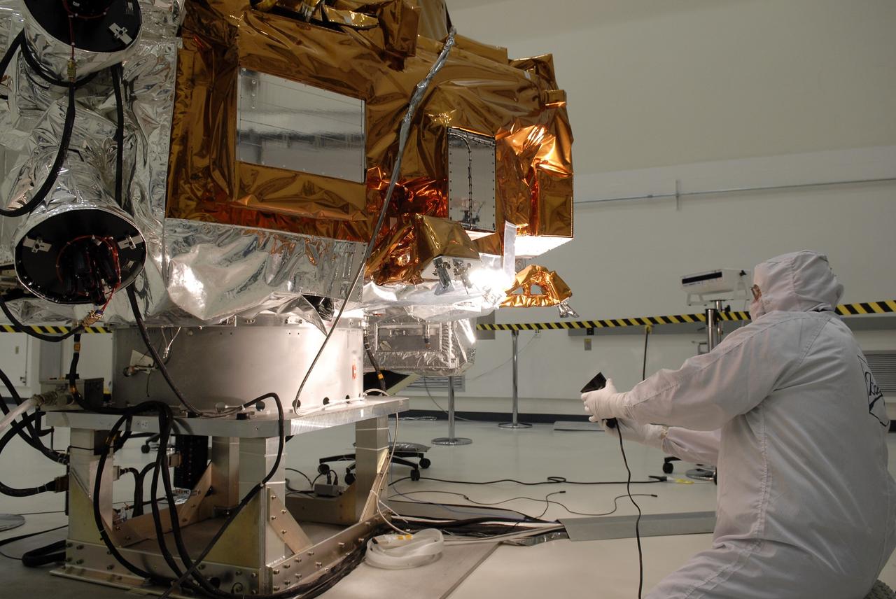 CAPE CANAVERAL, Fla. -- At the Astrotech payload processing facility in Titusville, Fla., a Ball Aerospace and Technologies Corp. worker conducts a light sensor test on NASA's Kepler spacecraft. A NASA Discovery mission, Kepler is specifically designed to survey our region of the Milky Way galaxy to discover hundreds of Earth-size and smaller planets in or near the habitable zone and determine how many of the billions of stars in our galaxy have such planets. Results from this mission will allow us to place our solar system within the continuum of planetary systems in the Galaxy. After processing at Astrotech, Kepler will be carried to its launch pad at Cape Canaveral Air Force Station. .NASA's planet-hunting Kepler mission is scheduled to launch no earlier than March 5 atop a United Launch Alliance Delta II rocket. Photo credit: NASA/Kim Shiflett
