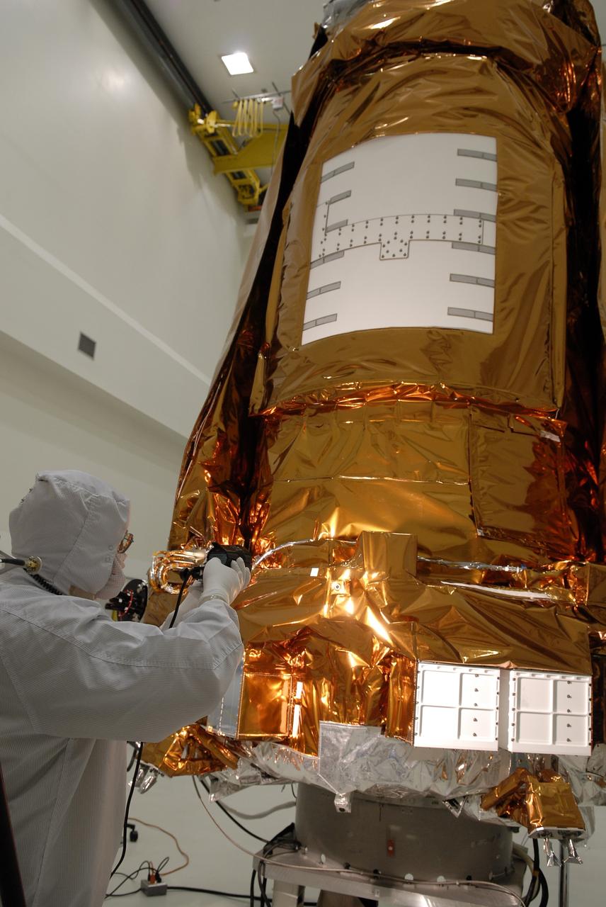 CAPE CANAVERAL, Fla. -- At the Astrotech payload processing facility in Titusville, Fla., a Ball Aerospace and Technologies Corp. worker conducts a light sensor test on NASA's Kepler spacecraft. A NASA Discovery mission, Kepler is specifically designed to survey our region of the Milky Way galaxy to discover hundreds of Earth-size and smaller planets in or near the habitable zone and determine how many of the billions of stars in our galaxy have such planets. Results from this mission will allow us to place our solar system within the continuum of planetary systems in the Galaxy. After processing at Astrotech, Kepler will be carried to its launch pad at Cape Canaveral Air Force Station. .NASA's planet-hunting Kepler mission is scheduled to launch no earlier than March 5 atop a United Launch Alliance Delta II rocket. Photo credit: NASA/Kim Shiflett