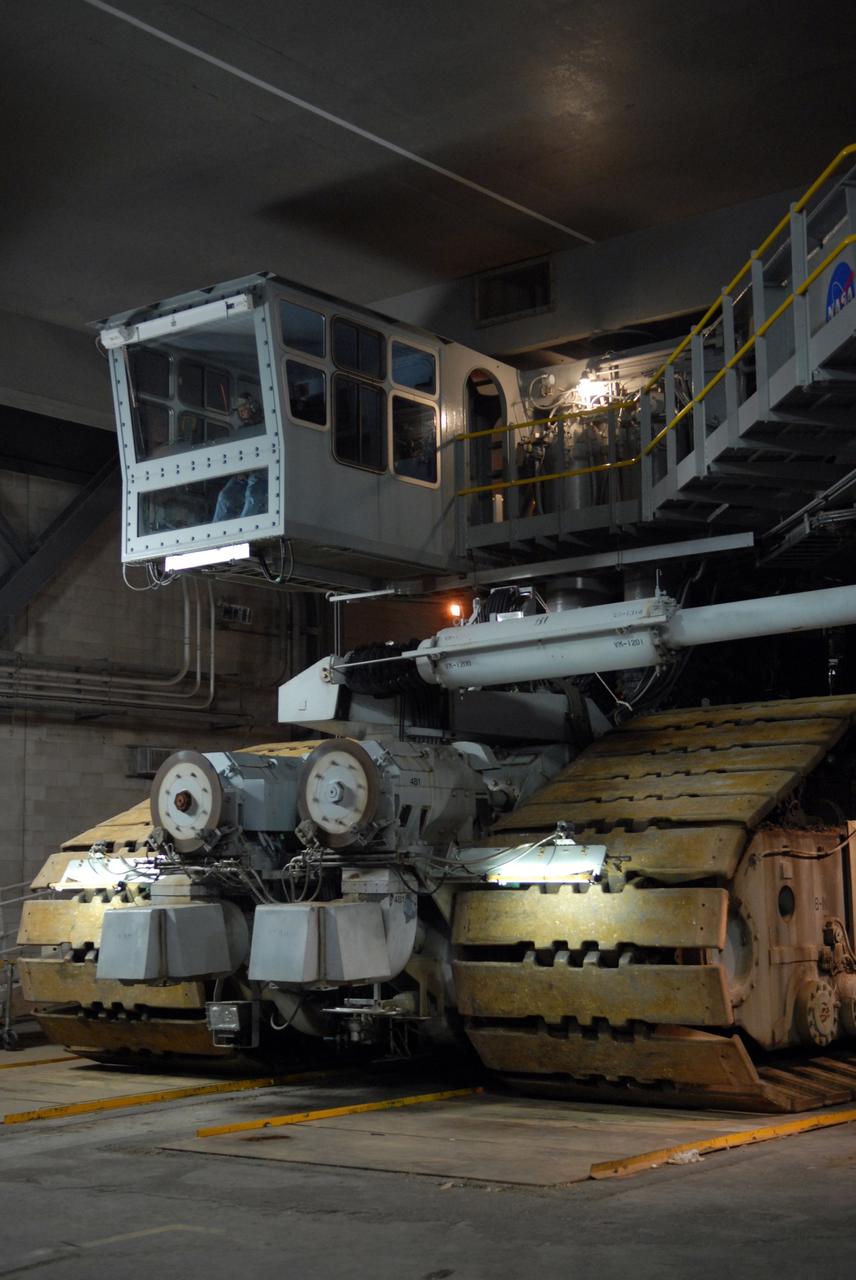 CAPE CANAVERAL, Fla. -- The massive crawler-transporter begins moving its cargo of space shuttle Discovery and mobile launcher platform out of the Vehicle Assembly Building at NASA's Kennedy Space Center in Florida to Launch Pad 39A. At upper left is one of the two operator control cabs, one at each end of the chassis, used to control all crawler systems. First motion was at 5:17 a.m. EST. Discovery is targeted to launch to the International Space Station Feb. 12. During Discovery's 14-day mission, the crew will install the S6 truss segment and its solar arrays to the starboard side of the station, completing the station's backbone, or truss, enabling a six-person crew to live there starting in May. Photo credit: NASA/Troy Cryder