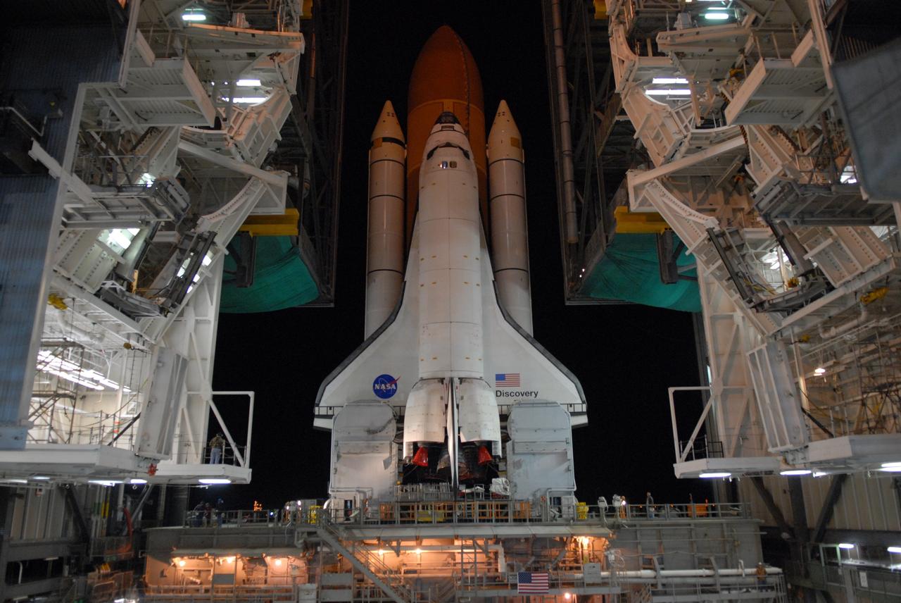 CAPE CANAVERAL, Fla. -- Space shuttle Discovery atop the mobile launcher platform moves on the crawler-transporter through the doors of the Vehicle Assembly Building at NASA's Kennedy Space Center in Florida on its way to Launch pad 39A. First motion was at 5:17 a.m. EST. Discovery is targeted to launch to the International Space Station Feb. 12. During Discovery's 14-day mission, the crew will install the S6 truss segment and its solar arrays to the starboard side of the station, completing the station's backbone, or truss, enabling a six-person crew to live there starting in May. Photo credit: NASA/Troy Cryder