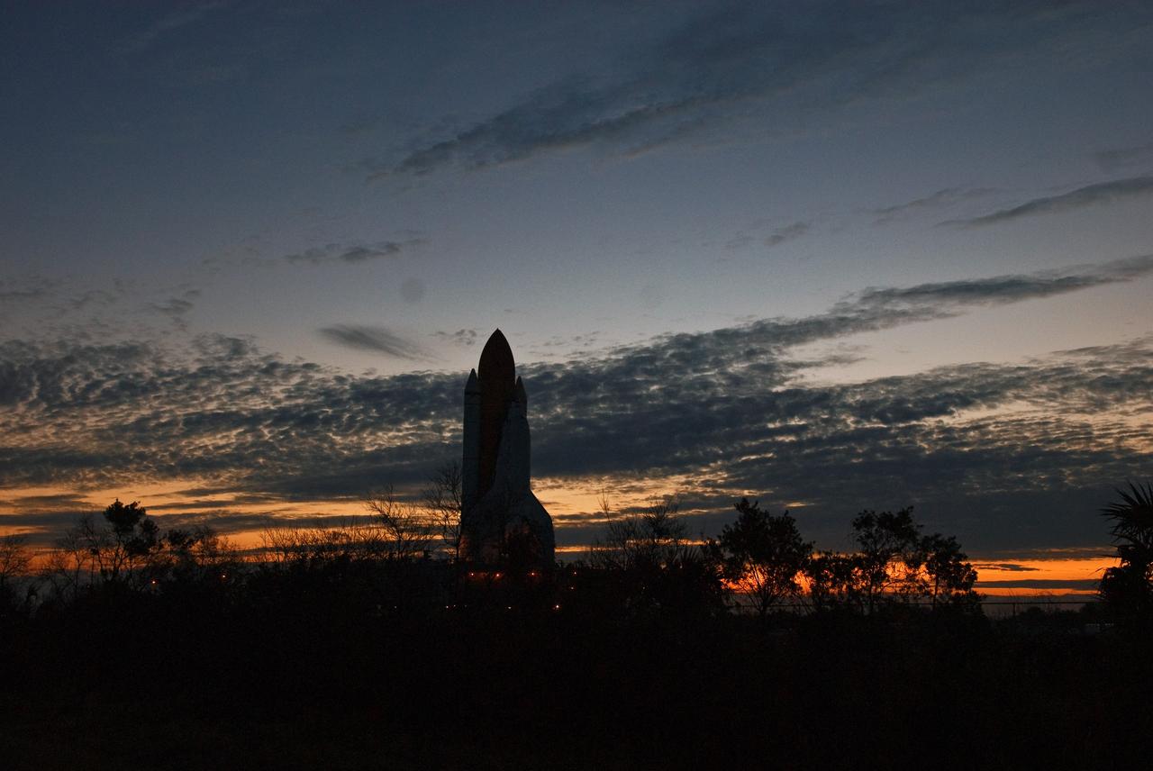 CAPE CANAVERAL, Fla. -- Space shuttle Discovery looms against the pre-dawn, cloud-streaked sky as it makes the slow 3.4-mile journey to Launch Pad 39A. The shuttle sits atop the mobile launcher platform, which are being moved by the massive crawler-transporter beneath. First motion out of the Vehicle Assembly Building was at 5:17 a.m. EST. Discovery is targeted to launch to the International Space Station Feb. 12. During Discovery's 14-day mission, the crew will install the S6 truss segment and its solar arrays to the starboard side of the station, completing the station's backbone, or truss, enabling a six-person crew to live there starting in May. Photo credit: NASA/Troy Cryder