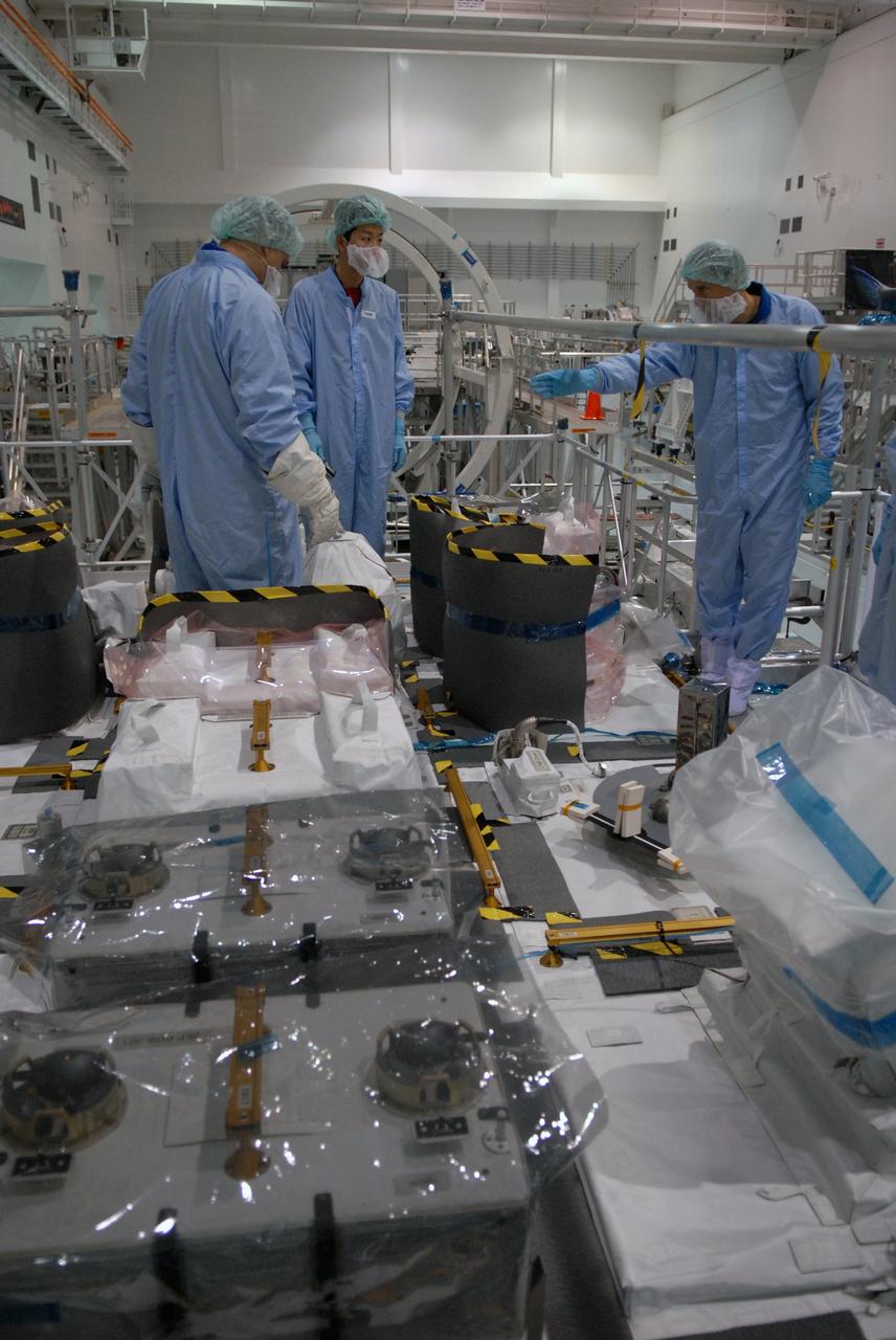 CAPE CANAVERAL, Fla. – In the Space Station Processing Facility at NASA's Kennedy Space Center in Florida, members of the STS-127 crew look over equipment on the Japanese Experiment Module's Experiment Logistics Module-Exposed Section, or ELM-ES, part of the payload on the mission.  The crew is  Commander Mark Polansky, Pilot Doug Hurley and Mission Specialists Christopher Cassidy, Tom Marshburn, Dave Wolf, Julie Payette and Tim Kopra. They are at Kennedy for Crew Equipment Interface Test activities, or CEIT, which provides experience handling tools, equipment and hardware for the mission.  The payload will be launched to the International Space Station aboard space shuttle Endeavour on the STS-127 mission, targeted for launch on May 15. Photo credit: NASA/Dimitrios Gerondidakis