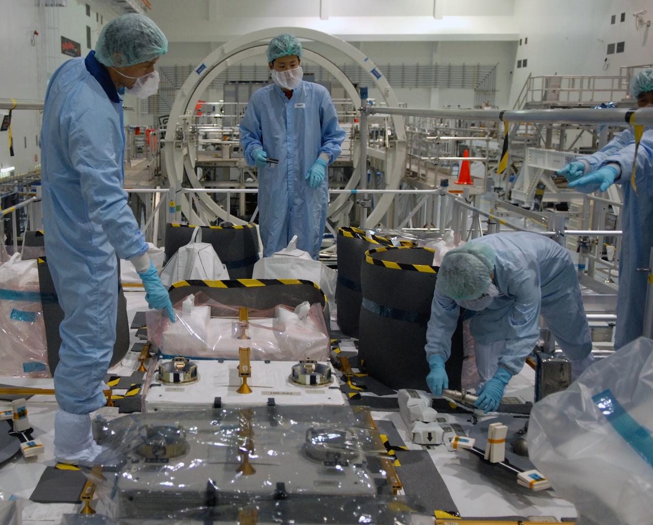 CAPE CANAVERAL, Fla. – In the Space Station Processing Facility at NASA's Kennedy Space Center in Florida, members of the STS-127 crew check out equipment on the Japanese Experiment Module's Experiment Logistics Module-Exposed Section, or ELM-ES, part of the payload on the mission.  The crew is  Commander Mark Polansky, Pilot Doug Hurley and Mission Specialists Christopher Cassidy, Tom Marshburn, Dave Wolf, Julie Payette and Tim Kopra. They are at Kennedy for Crew Equipment Interface Test activities, or CEIT, which provides experience handling tools, equipment and hardware for the mission.  The payload will be launched to the International Space Station aboard space shuttle Endeavour on the STS-127 mission, targeted for launch on May 15. Photo credit: NASA/Dimitrios Gerondidakis