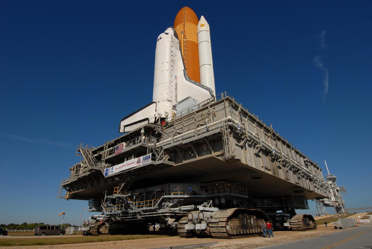 CAPE CANAVERAL, Fla. -- Space shuttle Discovery, atop the mobile launcher platform and crawler-transporter, approaches the ramp to Launch Pad 39A at NASA's Kennedy Space Center in Florida. First motion out of the Vehicle Assembly Building was at 5:17 a.m. EST.  Discovery was secured to the pad at 12:16 p.m.  Discovery is targeted to launch to the International Space Station Feb. 12. During Discovery's 14-day mission, the crew will install the S6 truss segment and its solar arrays to the starboard side of the station, completing the station's backbone, or truss, enabling a six-person crew to live there starting in May.  Photo credit: NASA/Troy Cryder