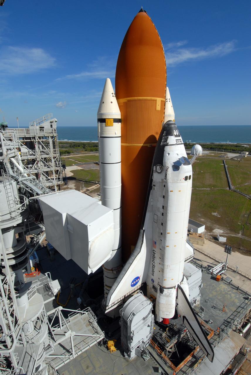 CAPE CANAVERAL, Fla. -- Space shuttle Discovery, atop the mobile launcher platform, reaches the top of Launch Pad 39A at NASA's Kennedy Space Center in Florida. At left is the White Room, attached to the end of the orbiter access arm.  Behind the shuttle can be seen the Atlantic Ocean. Discovery's first motion out of the Vehicle Assembly Building was at 5:17 a.m. EST.  Discovery was secured to the pad at 12:16 p.m.  Discovery is targeted to launch to the International Space Station Feb. 12. During Discovery's 14-day mission, the crew will install the S6 truss segment and its solar arrays to the starboard side of the station, completing the station's backbone, or truss, enabling a six-person crew to live there starting in May.  Photo credit: NASA/Troy Cryder
