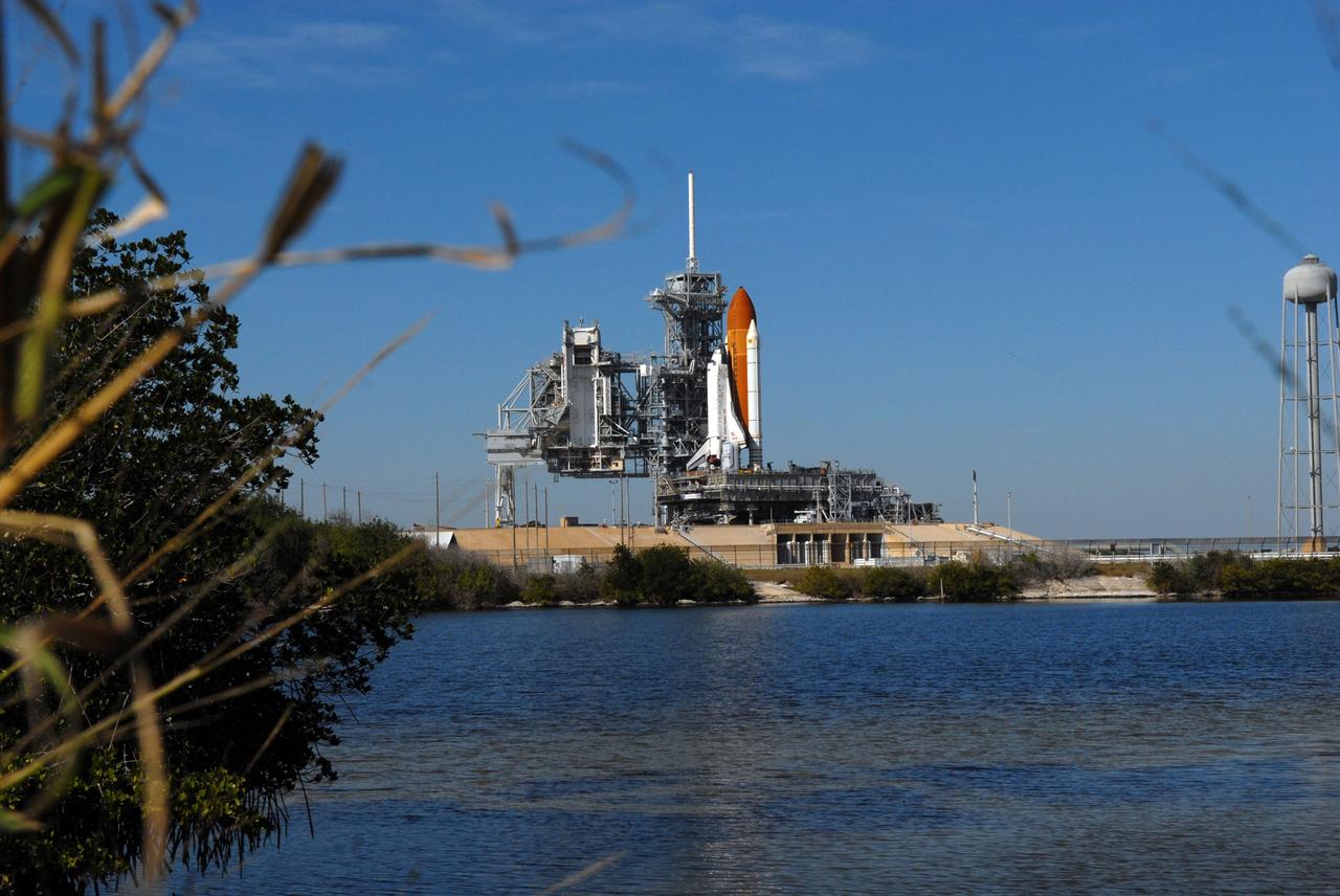 CAPE CANAVERAL, Fla. -- Viewed across the waters of the Banana River at NASA's Kennedy Space Center in Florida, space shuttle Discovery is secured on Launch Pad 39A.  First motion was at 5:17 a.m. EST.  Discovery was secured to the pad at 12:16 p.m.  Discovery is targeted to launch to the International Space Station Feb. 12. During Discovery's 14-day mission, the crew will install the S6 truss segment and its solar arrays to the starboard side of the station, completing the station's backbone, or truss, enabling a six-person crew to live there starting in May.  Photo credit: NASA/Troy Cryder