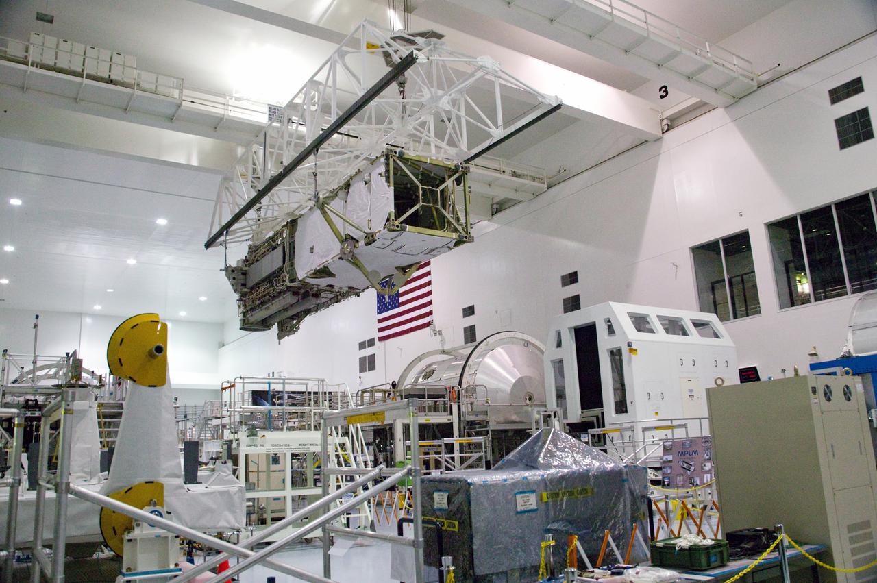 CAPE CANAVERAL, Fla. – In the Space Station Processing Facility at NASA's Kennedy Space Center in Florida, the integrated truss structure, S6, and solar arrays are lifted across the floor to install in the payload canister for transfer to Launch Pad 39A. The truss and arrays are space shuttle Discovery's payload for the STS-119 mission to the International Space Station. Launch of Discovery on the STS-119 mission is targeted for Feb. 12. During Discovery's 14-day mission, the crew will install the S6 truss segment and its solar arrays to the starboard side of the station, completing the station's truss, or backbone. Photo credit: NASA/Kevin Gill