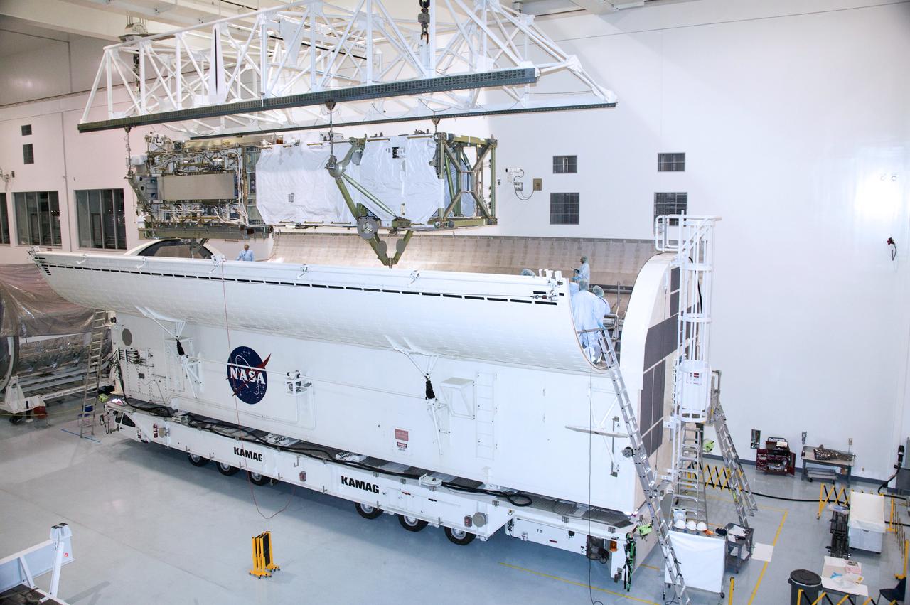 CAPE CANAVERAL, Fla. – In the Space Station Processing Facility at NASA's Kennedy Space Center in Florida, the integrated truss structure, S6, and solar arrays are lowered into the payload canister for transfer to Launch Pad 39A. Launch of Discovery on the STS-119 mission is targeted for Feb. 12. During Discovery's 14-day mission, the crew will install the S6 truss segment and its solar arrays to the starboard side of the station, completing the station's truss, or backbone. Photo credit: NASA/Kevin Gill