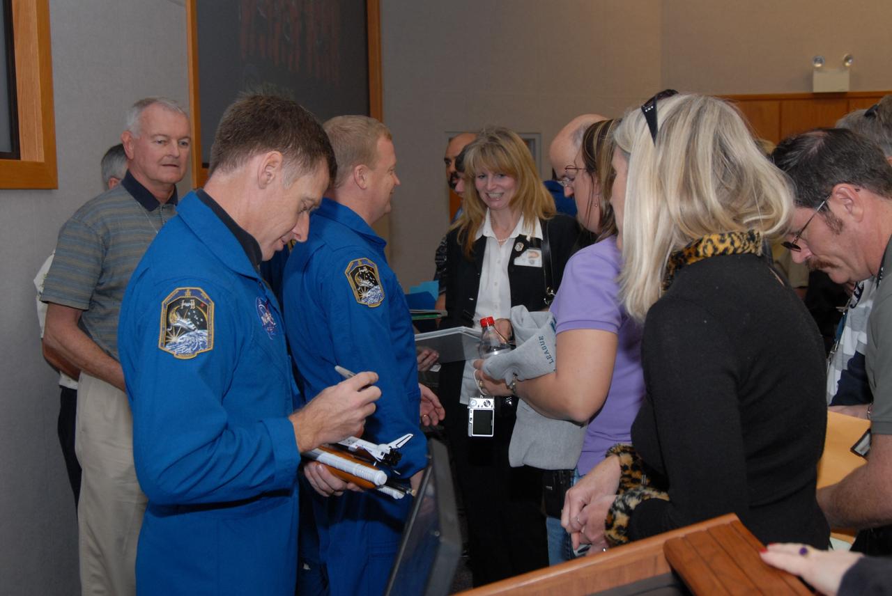 CAPE CANAVERAL, Fla. – At NASA's Kennedy Space Center in Florida, STS-126 crew members sign autographs for Kennedy workers who attended the astronauts' presentation of their experiences during the mission. In front is Commander Chris Ferguson; behind him in the center is Pilot Eric Boe. Photo credit: NASA/Dimitrios Gerondidakis