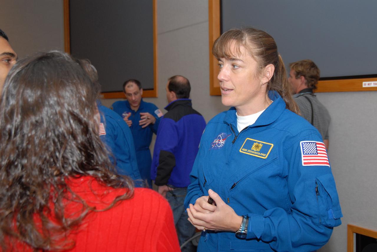 CAPE CANAVERAL, Fla. – At NASA's Kennedy Space Center in Florida, STS-126 Mission Specialist Heidemarie Stefanyshyn-Piper talks with Kennedy workers after the crew's presentation of shared experiences during the mission. In the background is Mission Specialist Donald Pettit talking to workers. Photo credit: NASA/Dimitrios Gerondidakis