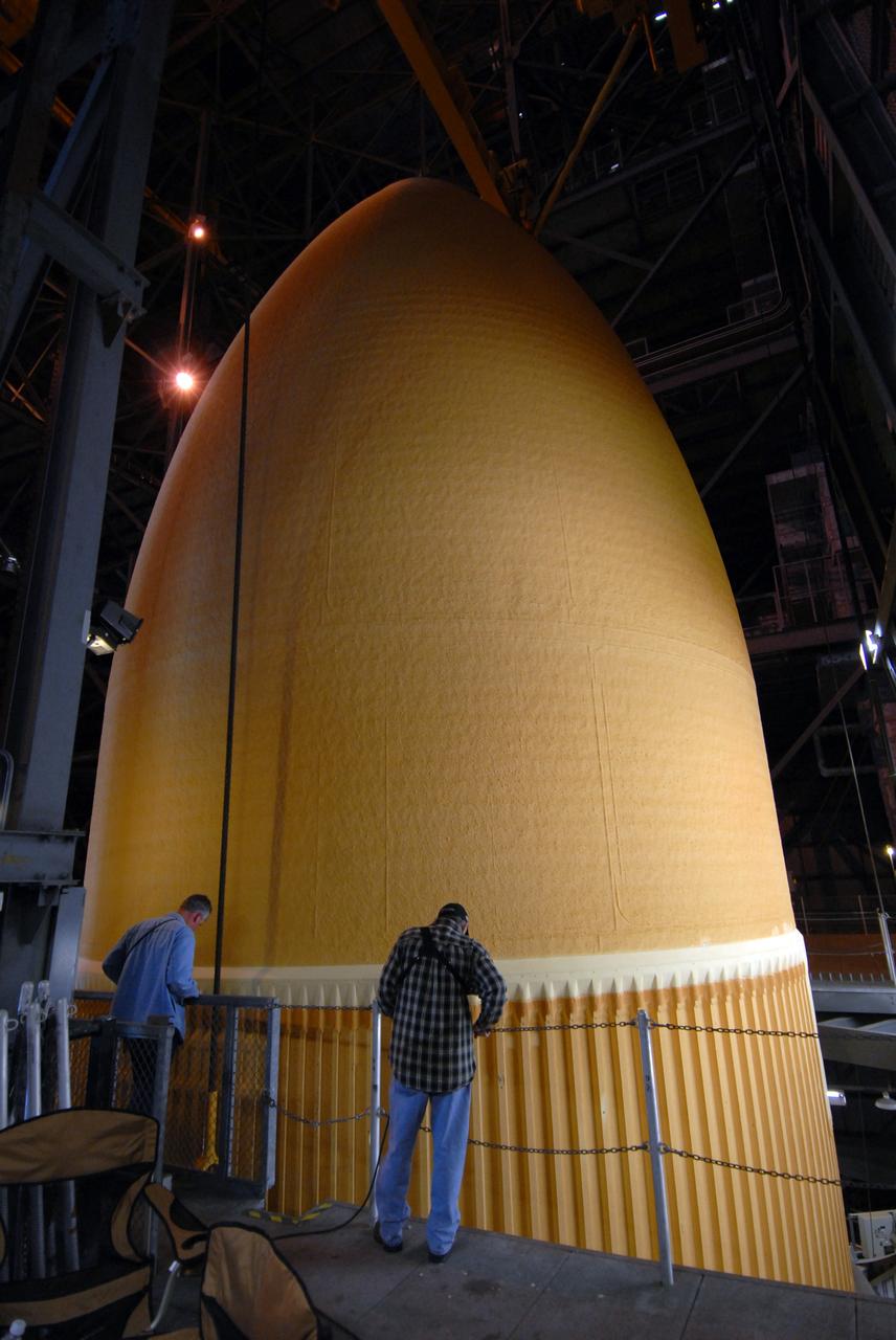 CAPE CANAVERAL, Fla. –  In the Vehicle Assembly Building at NASA's Kennedy Space Center in Florida, the external fuel tank for space shuttle Atlantis' STS-125 mission is raised from the checkout cell in order to move it to high bay 3.  There it will be lowered onto the mobile launcher platform and attached to the solid rocket boosters already installed. Atlantis' STS-125 mission is the fifth and final shuttle servicing mission to NASA’s Hubble Space Telescope.  Launch is targeted for May 12.  Photo credit: NASA/Jack Pfaller