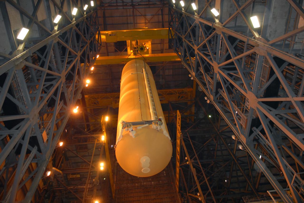 CAPE CANAVERAL, Fla. –  In the Vehicle Assembly Building at NASA's Kennedy Space Center in Florida, the external fuel tank for space shuttle Atlantis' STS-125 mission is lowered into high bay 3.  It will be installed on the mobile launcher platform and attached to the solid rocket boosters already there.  Atlantis' STS-125 mission is the fifth and final shuttle servicing mission to NASA’s Hubble Space Telescope.  Launch is targeted for May 12.  Photo credit: NASA/Jack Pfaller