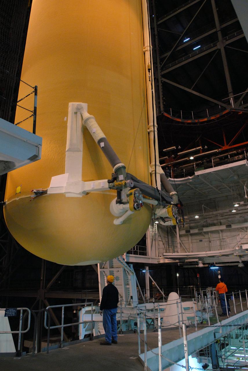 CAPE CANAVERAL, Fla. –  In the Vehicle Assembly Building at NASA's Kennedy Space Center in Florida, the external fuel tank for space shuttle Atlantis' STS-125 mission is lowered into high bay 3.  It will be installed on the mobile launcher platform and attached to the solid rocket boosters already there. Atlantis' STS-125 mission is the fifth and final shuttle servicing mission to NASA’s Hubble Space Telescope.  Launch is targeted for May 12.  Photo credit: NASA/Jack Pfaller