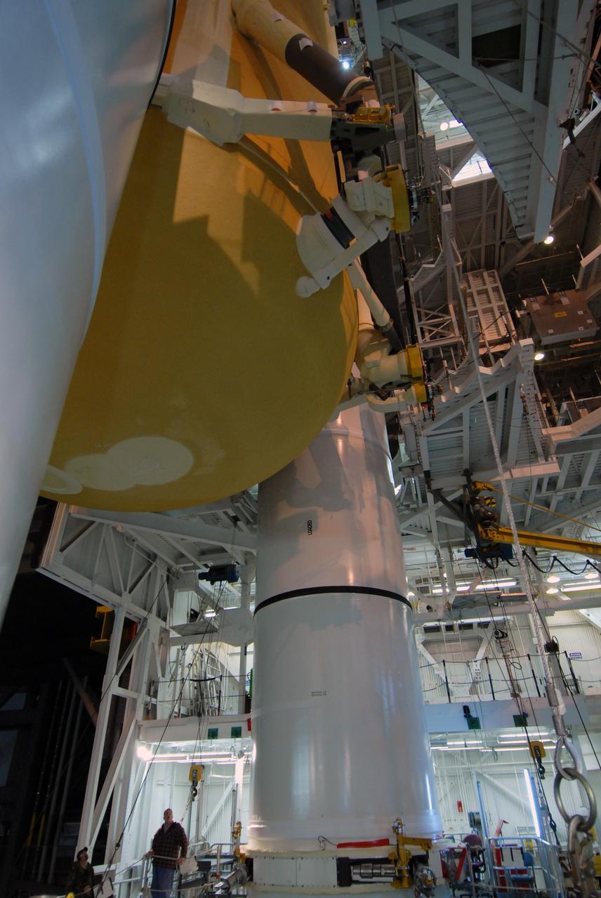 CAPE CANAVERAL, Fla. –  In the Vehicle Assembly Building at NASA's Kennedy Space Center in Florida, the external fuel tank for space shuttle Atlantis' STS-125 mission is lowered between the solid rocket boosters installed on the mobile launcher platform in high bay 3.  The tank and boosters will be attached for launch.  Atlantis' STS-125 mission is the fifth and final shuttle servicing mission to NASA’s Hubble Space Telescope.  Launch is targeted for May 12.  Photo credit: NASA/Jack Pfaller
