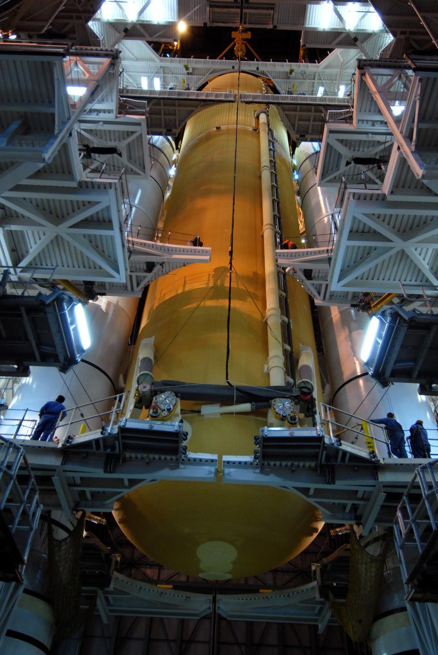 CAPE CANAVERAL, Fla. –  In the Vehicle Assembly Building at NASA's Kennedy Space Center in Florida, the external fuel tank for space shuttle Atlantis' STS-125 mission is lowered between the solid rocket boosters installed on the mobile launcher platform in high bay 3.  The tank and boosters will be attached for launch. Atlantis' STS-125 mission is the fifth and final shuttle servicing mission to NASA’s Hubble Space Telescope.  Launch is targeted for May 12.  Photo credit: NASA/Jack Pfaller