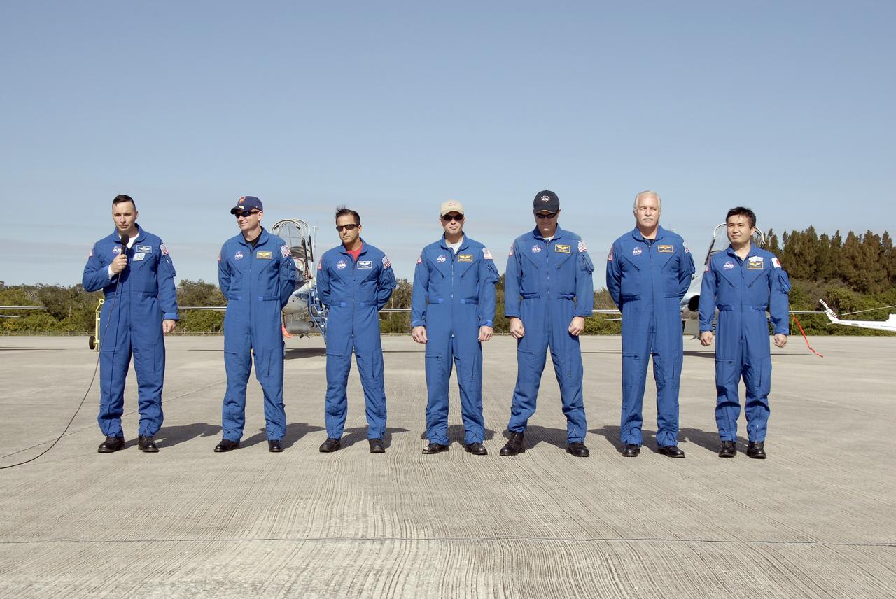 CAPE CANAVERAL, Fla. –   After arrival at the Shuttle Landing Facility at NASA's Kennedy Space Center in Florida, STS-119 Commander Lee Archambault greets the media.  He and other crew members explained their roles in the upcoming mission and answered reporters' questions.  Next to Archambault, from left, are Pilot Tony Antonelli, and Mission Specialists Joseph Acaba, Steve Swanson, Richard Arnold, John Phillips and Koichi Wakata. Wakata represents the Japan Aerospace Exploration Agency and will fly on the mission to the International Space Station to remain behind as a member of the Expedition 18 crew. The crew flew to Kennedy to take part in terminal countdown demonstration test activities, which include equipment familiarization and emergency exit training and culminate in a simulated launch countdown. Photo credit: NASA/Kim Shiflett