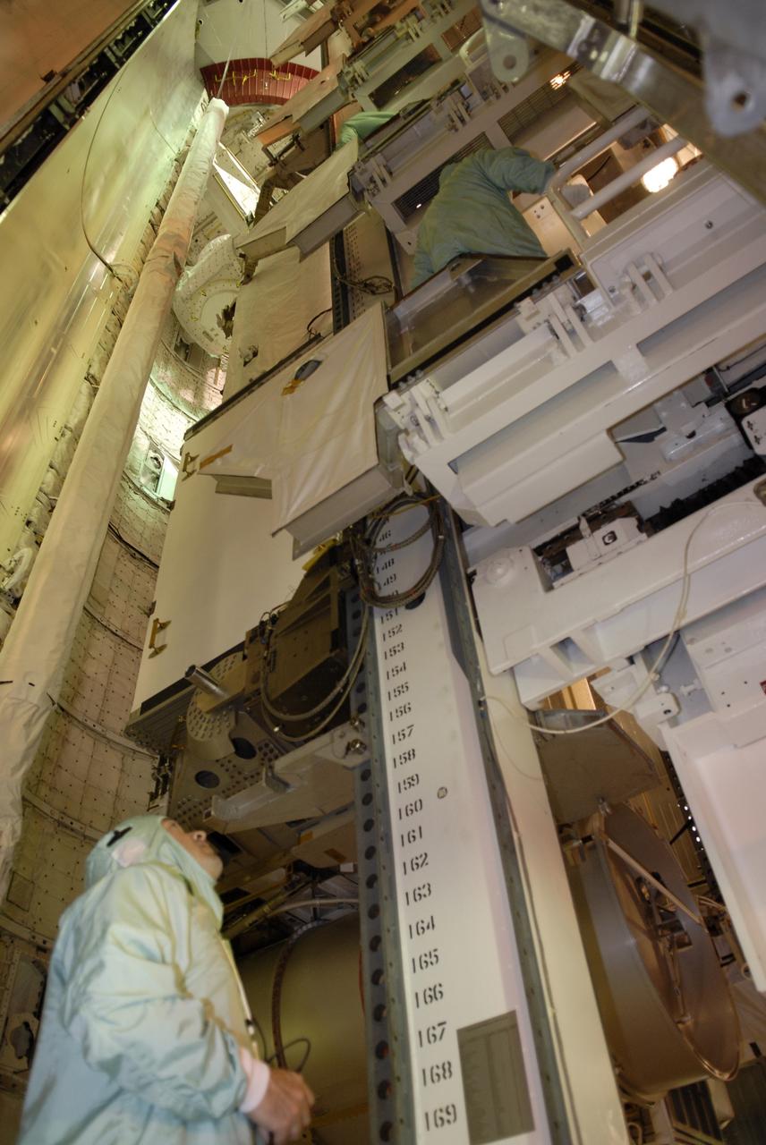 CAPE CANAVERAL, Fla. – On Launch Pad 39A at NASA's Kennedy Space Center in Florida, workers check the installation of the payload for the STS-119 mission in space shuttle Discovery's cargo bay. The payload consists of the integrated truss structure S6 and solar arrays. During Discovery's 14-day mission, the shuttle's seven astronauts will install the S6 truss segment and solar arrays to the starboard side of the International Space Station, completing the station's truss, or backbone. Launch of Discovery on the STS-119 mission is targeted for Feb. 12. Photo credit: NASA/Kim Shiflett
