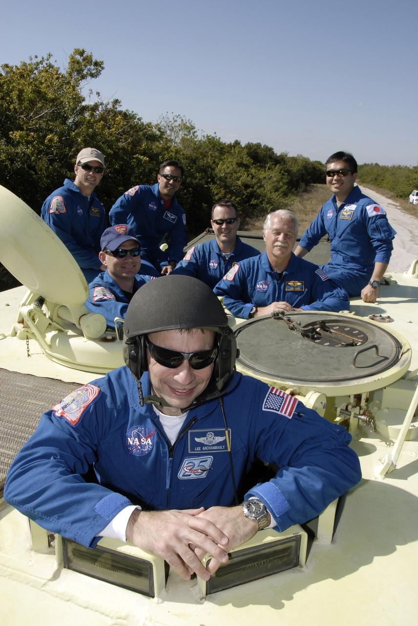 CAPE CANAVERAL, Fla. – At NASA's Kennedy Space Center in Florida, STS-119 Commander Lee Archambault is in the driver's seat of the M-113 armored personnel carrier used for emergency escape, if needed, from Launch Pad 39A. Other crew members behind him are (from left) Mission Specialist Steve Swanson, Pilot Tony Antonelli, and Mission Specialists Joseph Acaba, Richard Arnold, John Phillips and Koichi Wakata, who represents the Japan Aerospace Exploration Agency. The crew members are at Kennedy for prelaunch preparation known as terminal countdown demonstration test, or TCDT. The training provides astronauts and ground crews with an opportunity to participate in various simulated countdown activities, including equipment familiarization and a simulated launch countdown. The crew of space shuttle Discovery is targeted to launch on the STS-119 mission Feb. 12. During Discovery's 14-day mission, the crew will install the S6 truss segment and solar arrays to the starboard side of the International Space Station, completing the station's truss, or backbone. Photo credit: NASA/Kim Shiflett