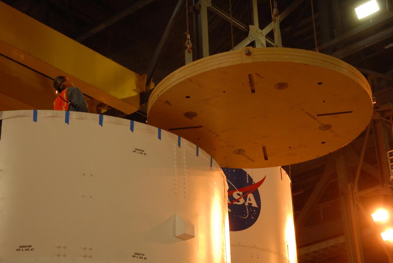 CAPE CANAVERAL, Fla. – In high bay 4 of the Vehicle Assembly Building at NASA's Kennedy Space Center in Florida, a ballast assembly is moved above the Ares I-X segment 7. Ballast assemblies will be installed in the upper stage 1 and 7 segments and will mimic the mass of the fuel. Their total weight is approximately 160,000 pounds. Ares I-X is the test vehicle for the Ares I, which is part of the Constellation Program to return men to the moon and beyond.  Ares I is the essential core of a safe, reliable, cost-effective space transportation system that eventually will carry crewed missions back to the moon, on to Mars and out into the solar system. Ares I may also use its 25-ton payload capacity to deliver resources and supplies to the International Space Station, or to "park" payloads in orbit for retrieval by other spacecraft bound for the moon or other destinations. The Ares I-X is targeted for launch in July 2009. Photo credit: NASA/Dimitri Gerondidakis
