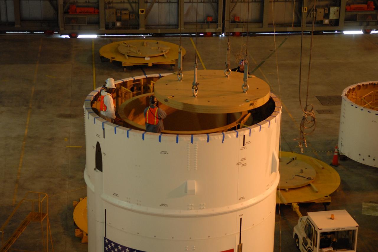 CAPE CANAVERAL, Fla. – In high bay 4 of the Vehicle Assembly Building at NASA's Kennedy Space Center in Florida, a ballast assembly is lowered into the Ares I-X segment 7. Ballast assemblies are being installed in the upper stage 1 and 7 segments and will mimic the mass of the fuel. Their total weight is approximately 160,000 pounds. Ares I-X is the test vehicle for the Ares I, which is part of the Constellation Program to return men to the moon and beyond.  Ares I is the essential core of a safe, reliable, cost-effective space transportation system that eventually will carry crewed missions back to the moon, on to Mars and out into the solar system. Ares I may also use its 25-ton payload capacity to deliver resources and supplies to the International Space Station, or to "park" payloads in orbit for retrieval by other spacecraft bound for the moon or other destinations. The Ares I-X is targeted for launch in July 2009. Photo credit: NASA/Dimitri Gerondidakis