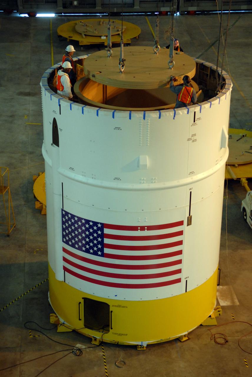 CAPE CANAVERAL, Fla. – In high bay 4 of the Vehicle Assembly Building at NASA's Kennedy Space Center in Florida, a ballast assembly is lowered into the Ares I-X segment 7. Ballast assemblies are being installed in the upper stage 1 and 7 segments and will mimic the mass of the fuel. Their total weight is approximately 160,000 pounds.  Ares I-X is the test vehicle for the Ares I, which is part of the Constellation Program to return men to the moon and beyond.  Ares I is the essential core of a safe, reliable, cost-effective space transportation system that eventually will carry crewed missions back to the moon, on to Mars and out into the solar system. Ares I may also use its 25-ton payload capacity to deliver resources and supplies to the International Space Station, or to "park" payloads in orbit for retrieval by other spacecraft bound for the moon or other destinations. The Ares I-X is targeted for launch in July 2009. Photo credit: NASA/Dimitri Gerondidakis