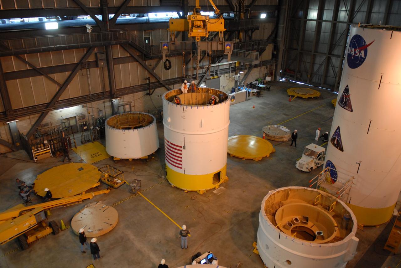 CAPE CANAVERAL, Fla. – In high bay 4 of the Vehicle Assembly Building at NASA's Kennedy Space Center in Florida, a ballast assembly is lowered into the Ares I-X segment 7 (at center). Ballast assemblies are being installed in the upper stage 1 and 7 segments and will mimic the mass of the fuel. Their total weight is approximately 160,000 pounds.  Ares I-X is the test vehicle for the Ares I, which is part of the Constellation Program to return men to the moon and beyond.  Ares I is the essential core of a safe, reliable, cost-effective space transportation system that eventually will carry crewed missions back to the moon, on to Mars and out into the solar system. Ares I may also use its 25-ton payload capacity to deliver resources and supplies to the International Space Station, or to "park" payloads in orbit for retrieval by other spacecraft bound for the moon or other destinations. The Ares I-X is targeted for launch in July 2009. Photo credit: NASA/Dimitri Gerondidakis