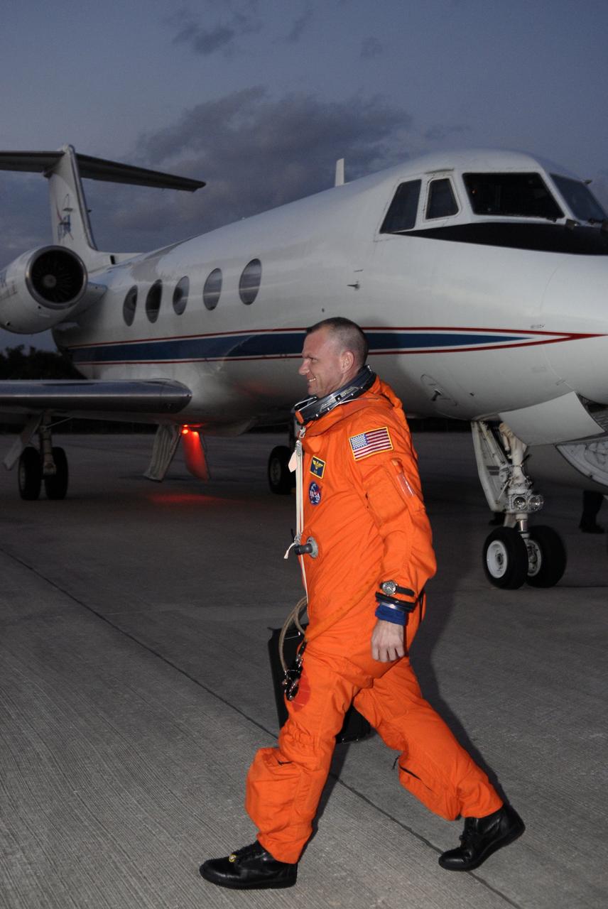 CAPE CANAVERAL, Fla. – STS-119 Pilot Tony Antonelli heads across the tarmac of the Shuttle Landing Facility at NASA's Kennedy Space Center in Florida to practice shuttle landings in the shuttle training aircraft, or STA.  Antonelli and the rest of the crew are at Kennedy to prepare for launch as part of the Terminal Countdown Demonstration Test activities. The TCDT includes equipment familiarization and a simulated launch countdown. The STA is a Grumman American Aviation-built Gulf Stream II jet that was modified to simulate a shuttle’s cockpit, motion and visual cues, and handling qualities. In flight, the aircraft duplicates the shuttle’s atmospheric descent trajectory from approximately 35,000 feet to landing. The crew of space shuttle Discovery is targeted to launch on the STS-119 mission Feb. 12. During Discovery's 14-day mission, the crew will install the S6 truss segment and solar arrays to the starboard side of the International Space Station, completing the station's truss, or backbone.   Photo credit: NASA/Kim Shiflett