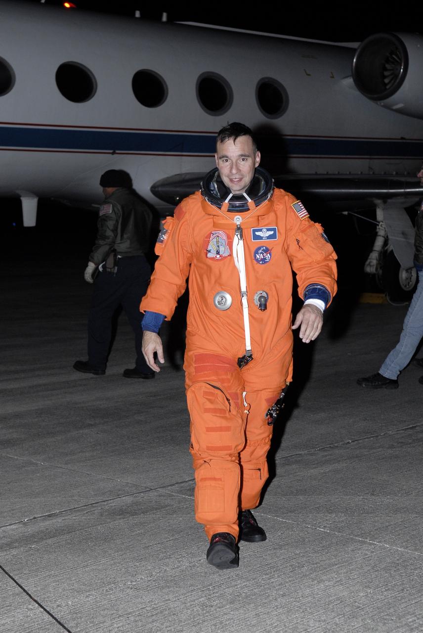 CAPE CANAVERAL, Fla. –   On the Shuttle Landing Facility at NASA's Kennedy Space Center in Florida, STS-119 Commander Lee Archambault  happily strides away from the shuttle training aircraft after successful practice landings. STS-119 Commander Lee Archambault and Pilot Tony Antonelli practiced shuttle landings as part of the Terminal Countdown Demonstration Test activities. The TCDT includes equipment familiarization and a simulated launch countdown.  The STA is a Grumman American Aviation-built Gulf Stream II jet that was modified to simulate a shuttle’s cockpit, motion and visual cues, and handling qualities. In flight, the aircraft duplicates the shuttle’s atmospheric descent trajectory from approximately 35,000 feet to landing. The crew of space shuttle Discovery is targeted to launch on the STS-119 mission Feb. 12. During Discovery's 14-day mission, the crew will install the S6 truss segment and solar arrays to the starboard side of the International Space Station, completing the station's truss, or backbone.   Photo credit: NASA/Kim Shiflett