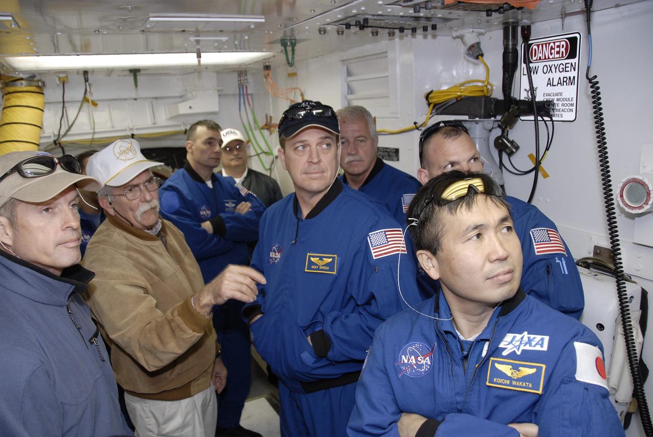 CAPE CANAVERAL, Fla. – The STS-119 crew members gather on the fixed service structure on Launch Pad 39A at NASA's Kennedy Space Center in Florida to start their emergency egress training. At left is Mission Specialist Steve Swanson; in the background is Commander Lee Archambault; on the right (from center) are Mission Specialists Richard Arnold and John Phillips, Pilot Tony Antonelli and Mission Specialist Koichi Wakata. The astronauts are at Kennedy to prepare for launch as part of the Terminal Countdown Demonstration Test activities. The TCDT includes equipment familiarization and a simulated launch countdown. The crew of space shuttle Discovery is targeted to launch on the STS-119 mission Feb. 12. During Discovery's 14-day mission, the crew will install the S6 truss segment and solar arrays to the starboard side of the International Space Station, completing the station's truss, or backbone. Photo credit: NASA/Kim Shiflett