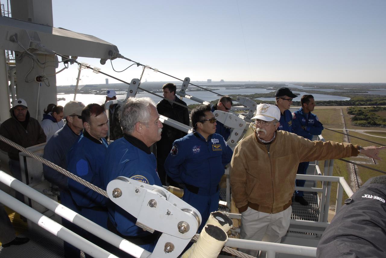 CAPE CANAVERAL, Fla. – On the fixed service structure on Launch Pad 39A at NASA's Kennedy Space Center in Florida, STS-119 crew members learn about slidewire basket procedures as part of emergency egress training. From left are Mission Specialist Steve Swanson, Commander Lee Archambault, Mission Specialists John Phillips, Koichi Wakata, and (behind the trainer) Richard Arnold and Joseph Acaba. The astronauts are at Kennedy to prepare for launch as part of the Terminal Countdown Demonstration Test activities. The TCDT includes equipment familiarization and a simulated launch countdown. The crew of space shuttle Discovery is targeted to launch on the STS-119 mission Feb. 12. During Discovery's 14-day mission, the crew will install the S6 truss segment and solar arrays to the starboard side of the International Space Station, completing the station's truss, or backbone. Photo credit: NASA/Kim Shiflett