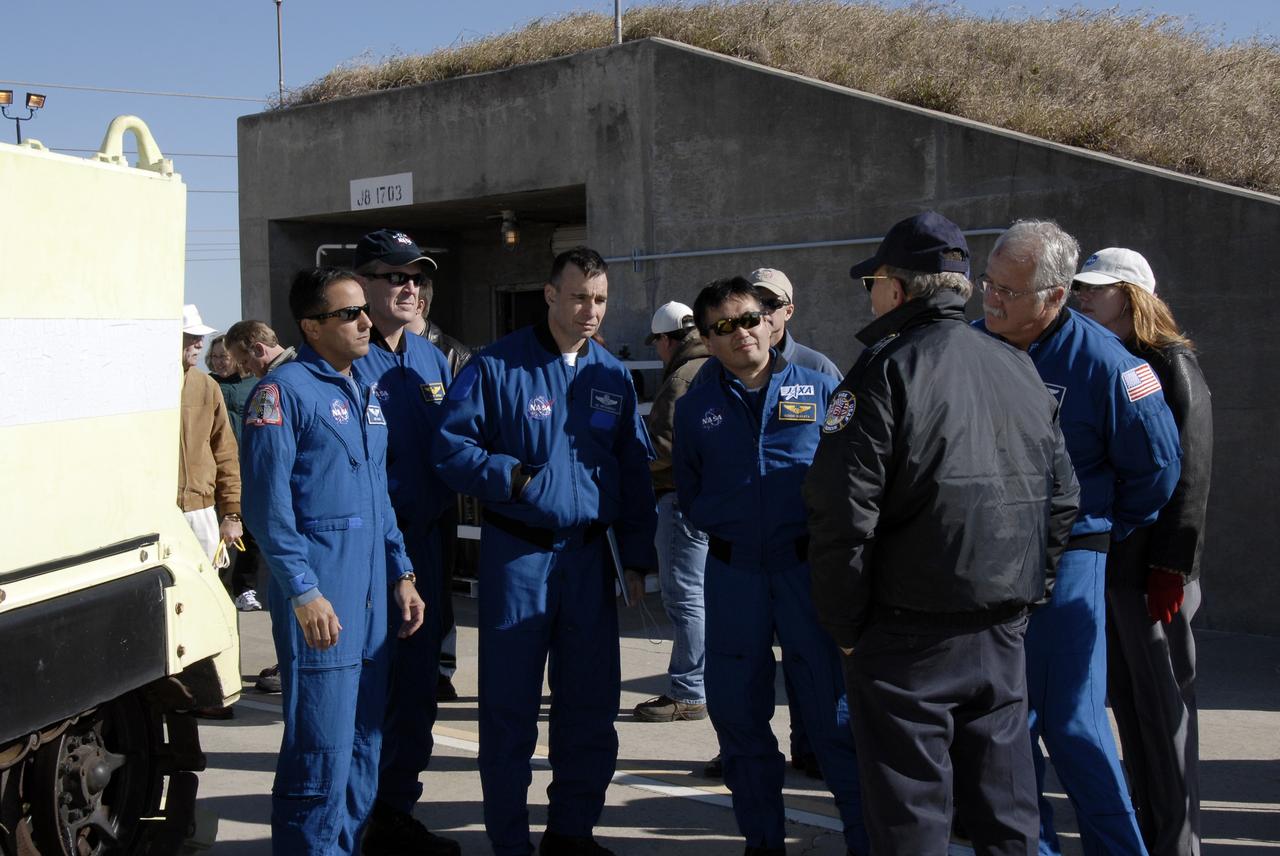 CAPE CANAVERAL, Fla. – On Launch Pad 39A at NASA's Kennedy Space Center in Florida, STS-119 crew members gather in front of the bunker to continue emergency egress training. From left are Mission Specialists Joseph Acaba and Richard Arnold, Pilot Tony Antonelli, and Mission Specialists Koichi Wakata, Steve Swanson (behind Wakata) and John Phillips (at right). The astronauts are at Kennedy to prepare for launch as part of the Terminal Countdown Demonstration Test activities. The TCDT includes equipment familiarization and a simulated launch countdown. The crew of space shuttle Discovery is targeted to launch on the STS-119 mission Feb. 12. During Discovery's 14-day mission, the crew will install the S6 truss segment and solar arrays to the starboard side of the International Space Station, completing the station's truss, or backbone. Photo credit: NASA/Kim Shiflett