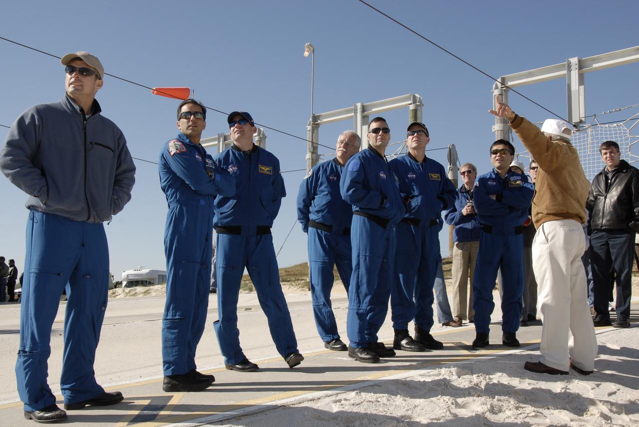 CAPE CANAVERAL, Fla. – On Launch Pad 39A at NASA's Kennedy Space Center in Florida, STS-119 crew members listen to instructions about using the slidewire baskets for emergency egress from the fixed service structure. From left are Mission Specialists Steve Swanson and Joseph Acaba, Pilot Tony Antonelli, Mission specialist John Phillips, Commander Lee Archambault and Mission Specialists Richard Arnold and Koichi Wakata. The astronauts are at Kennedy to prepare for launch as part of the Terminal Countdown Demonstration Test activities. The TCDT includes equipment familiarization and a simulated launch countdown. The crew of space shuttle Discovery is targeted to launch on the STS-119 mission Feb. 12. During Discovery's 14-day mission, the crew will install the S6 truss segment and solar arrays to the starboard side of the International Space Station, completing the station's truss, or backbone. Photo credit: NASA/Kim Shiflett