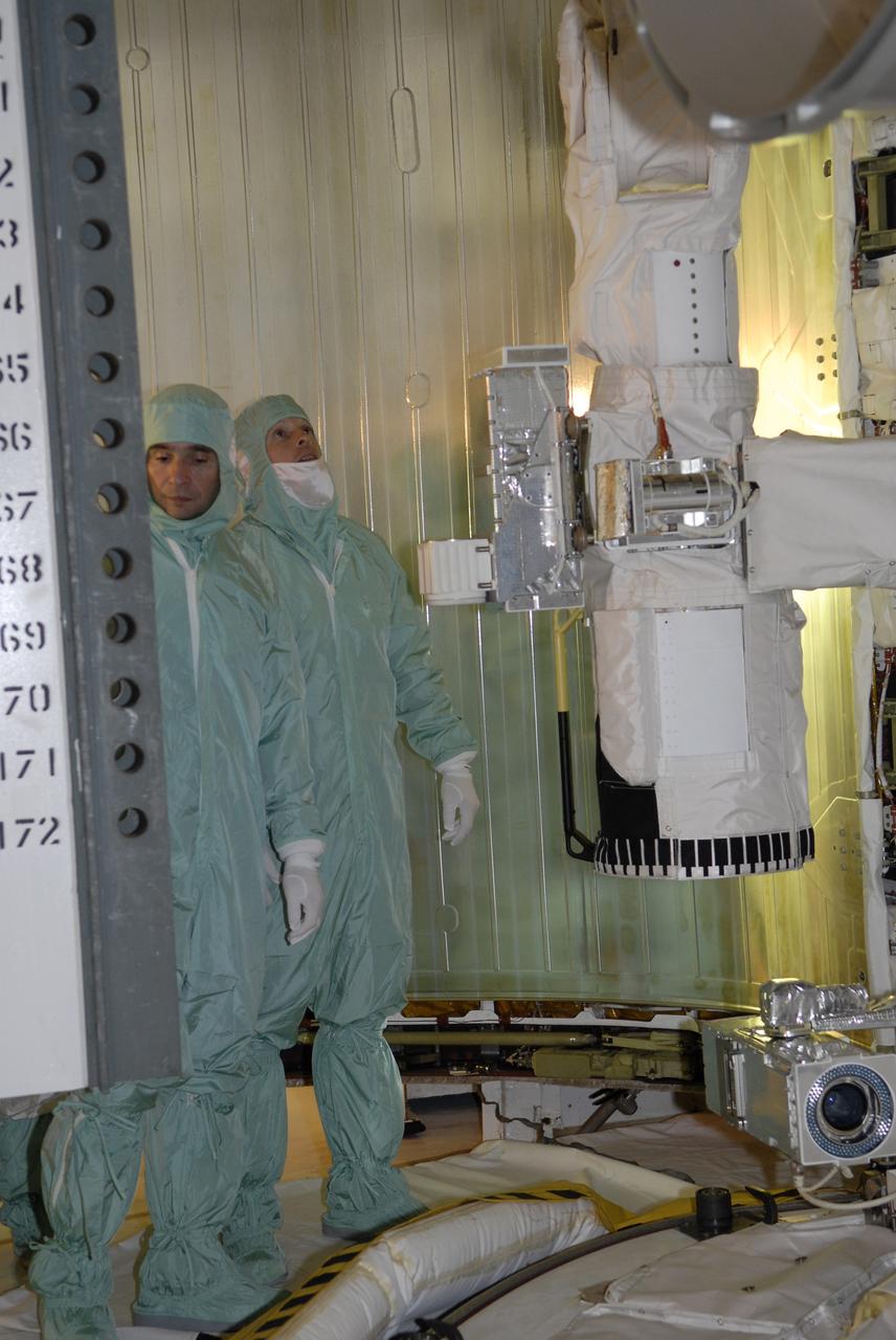 CAPE CANAVERAL, Fla. – On Launch Pad 39A at NASA's Kennedy Space Center in Florida, STS-119 crew members get a close look at the cargo – the integrated truss structure S6 and solar arrays -- installed in space shuttle Discovery's payload bay. Seen here are Commander Lee Archambault (left) and Mission Specialist Joseph Acaba. The astronauts are at Kennedy to prepare for launch through Terminal Countdown Demonstration Test activities. The TCDT includes equipment familiarization and a simulated launch countdown. Discovery is targeted to launch on the STS-119 mission Feb. 12. During Discovery's 14-day mission, the crew will install the S6 truss segment and solar arrays to the starboard side of the International Space Station, completing the station's truss, or backbone. Photo credit: NASA/Kim Shiflett