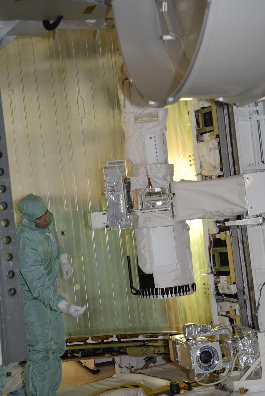 CAPE CANAVERAL, Fla. – On Launch Pad 39A at NASA's Kennedy Space Center in Florida, STS-119 Commander Lee Archambault inspects part of the cargo installed in space shuttle Discovery's payload bay. The cargo consists of the integrated truss structure S6 and solar arrays. The astronauts are at Kennedy to prepare for launch through Terminal Countdown Demonstration Test activities. The TCDT includes equipment familiarization and a simulated launch countdown. Discovery is targeted to launch on the STS-119 mission Feb. 12. During Discovery's 14-day mission, the crew will install the S6 truss segment and solar arrays to the starboard side of the International Space Station, completing the station's truss, or backbone. Photo credit: NASA/Kim Shiflett