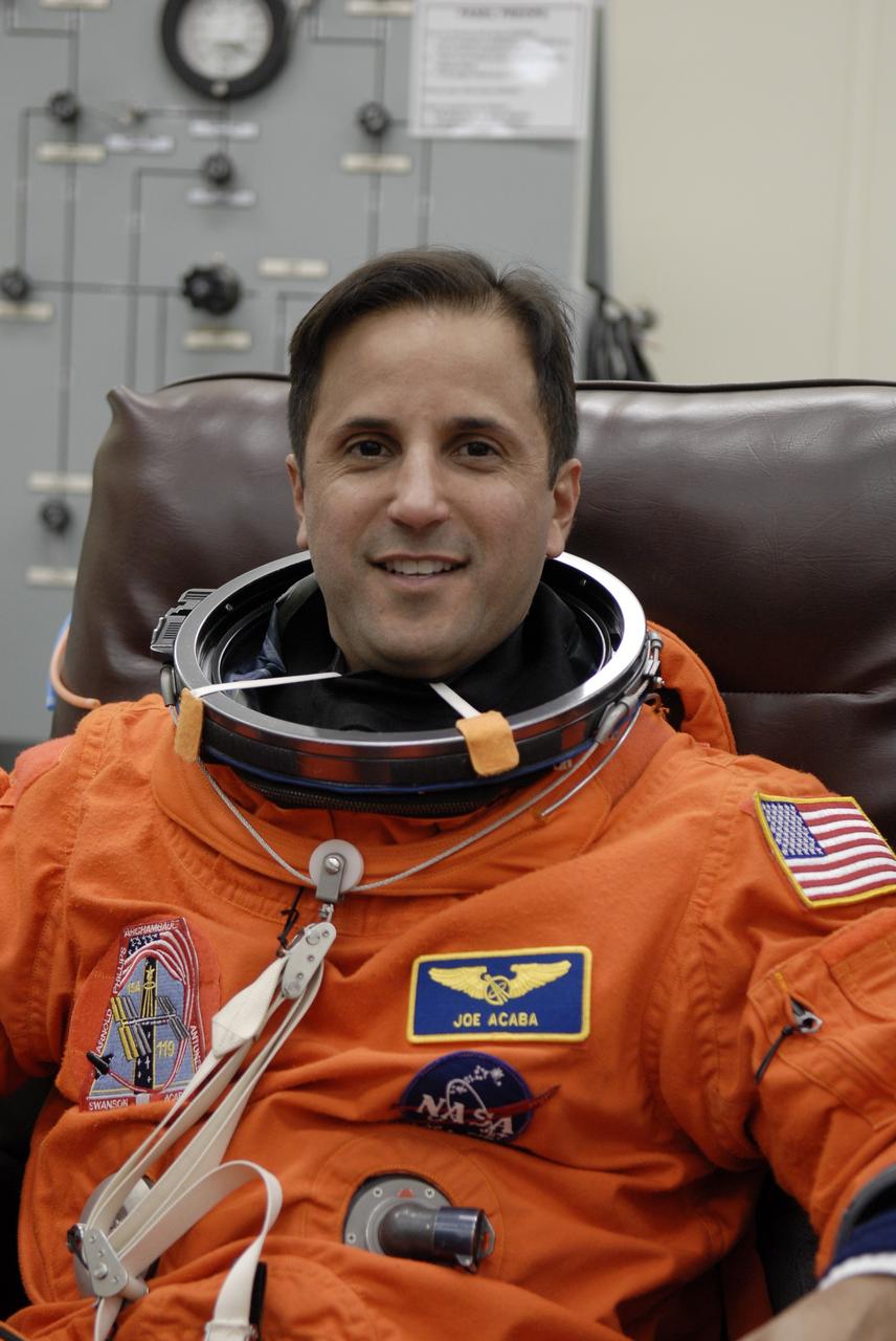 CAPE CANAVERAL, Fla. –   At NASA's Kennedy Space Center in Florida, STS-119 Mission Specialist Joseph Acaba is donning his launch-and-entry suit before heading to Launch Pad 39A for a simulated launch countdown. The astronauts are at Kennedy to prepare for launch through Terminal Countdown Demonstration Test activities. The TCDT includes equipment familiarization and emergency egress training. The crew is targeted to launch on the STS-119 mission Feb. 12 on space shuttle Discovery. During the 14-day mission, the crew will install the S6 truss segment and solar arrays to the starboard side of the International Space Station, completing the station's truss, or backbone.    Photo credit: NASA/Kim Shiflett