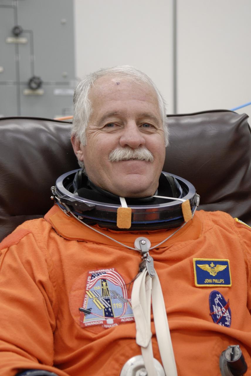 CAPE CANAVERAL, Fla. –   At NASA's Kennedy Space Center in Florida, STS-119 Mission Specialist John Phillips is donning his launch-and-entry suit before heading to Launch Pad 39A for a simulated launch countdown. The astronauts are at Kennedy to prepare for launch through Terminal Countdown Demonstration Test activities. The TCDT includes equipment familiarization and emergency egress training. The crew is targeted to launch on the STS-119 mission Feb. 12 on space shuttle Discovery. During the 14-day mission, the crew will install the S6 truss segment and solar arrays to the starboard side of the International Space Station, completing the station's truss, or backbone.    Photo credit: NASA/Kim Shiflett